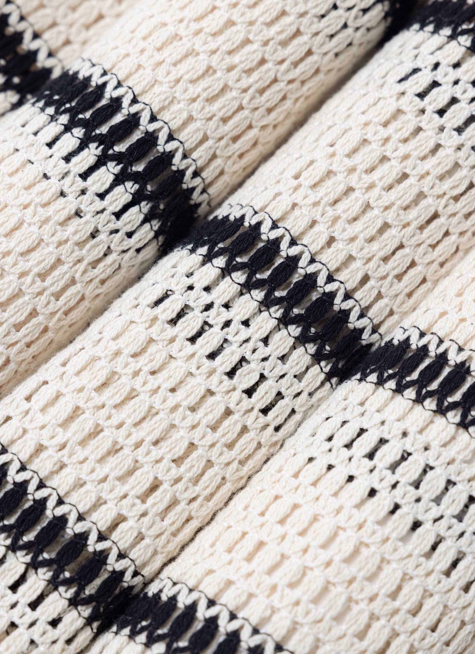 A close-up of the folded Percival Crochet Groundsman Cuban Shirt, showing the detailed ecru and black crochet knit.