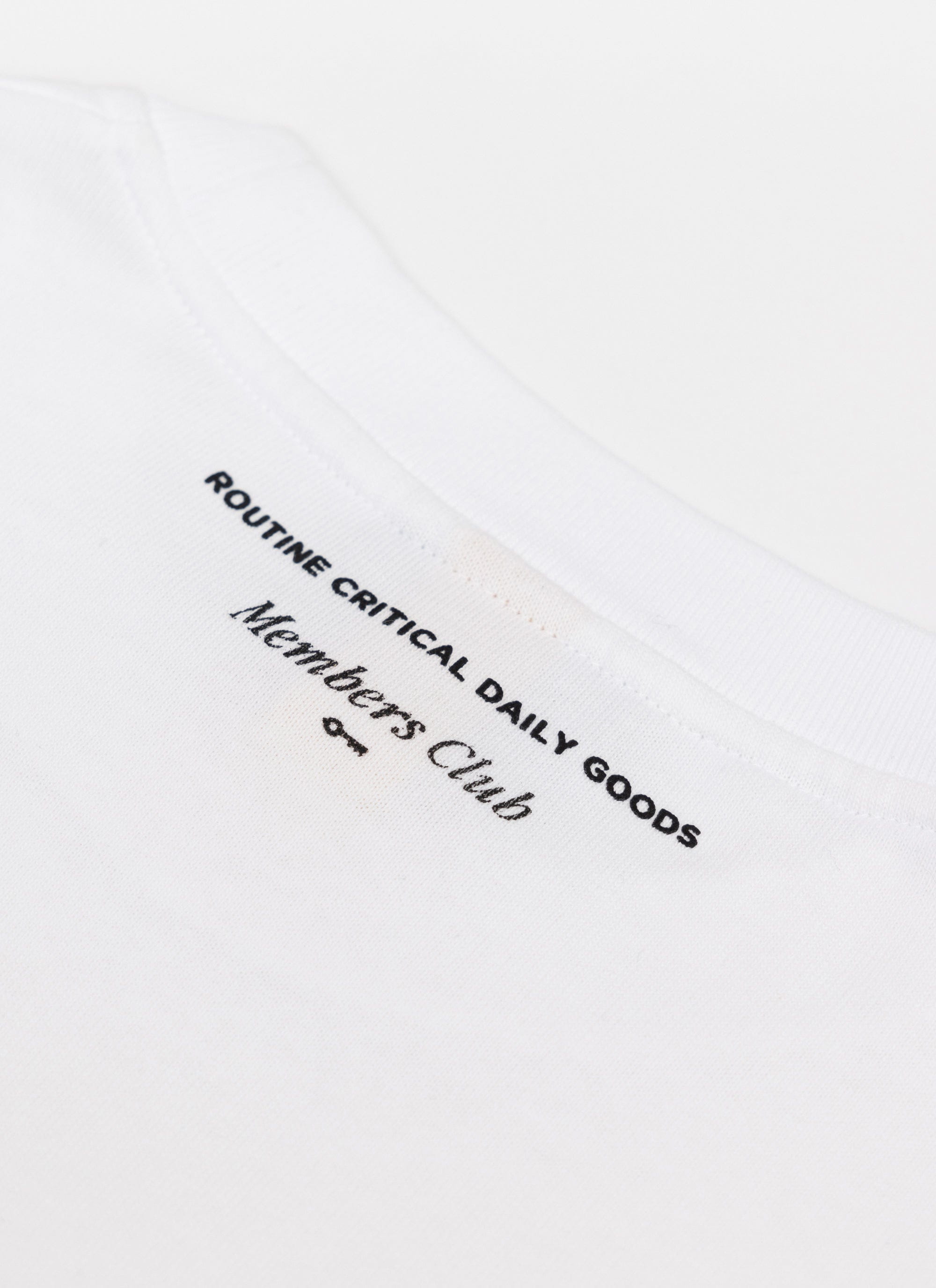 A close-up of the white Percival Loyalty T Shirt, showing the black 'Members Club' embroidery on the chest.