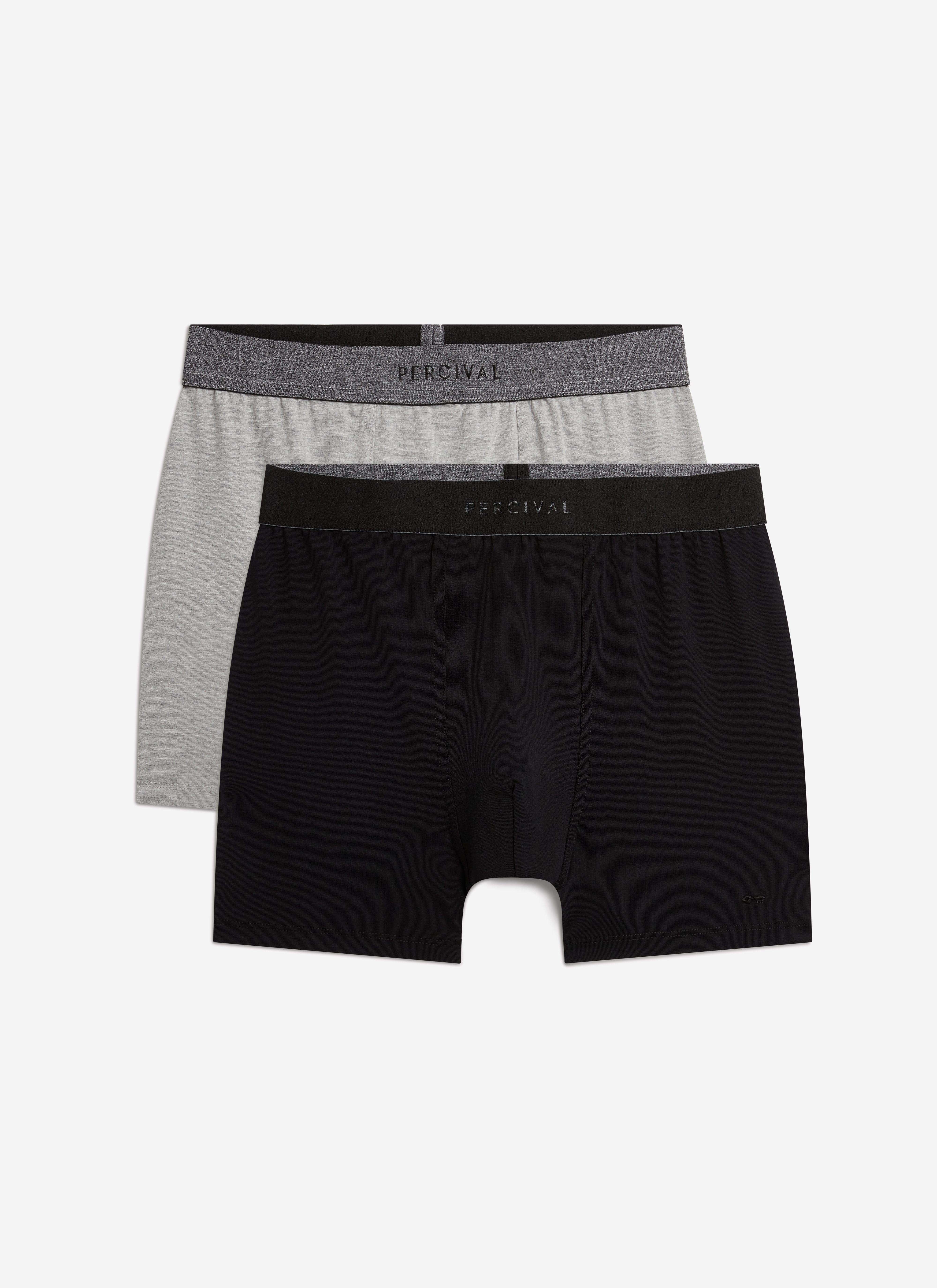 A pair of black and a pair of grey cotton stretch trunks from Percival, shown flat against a white background.