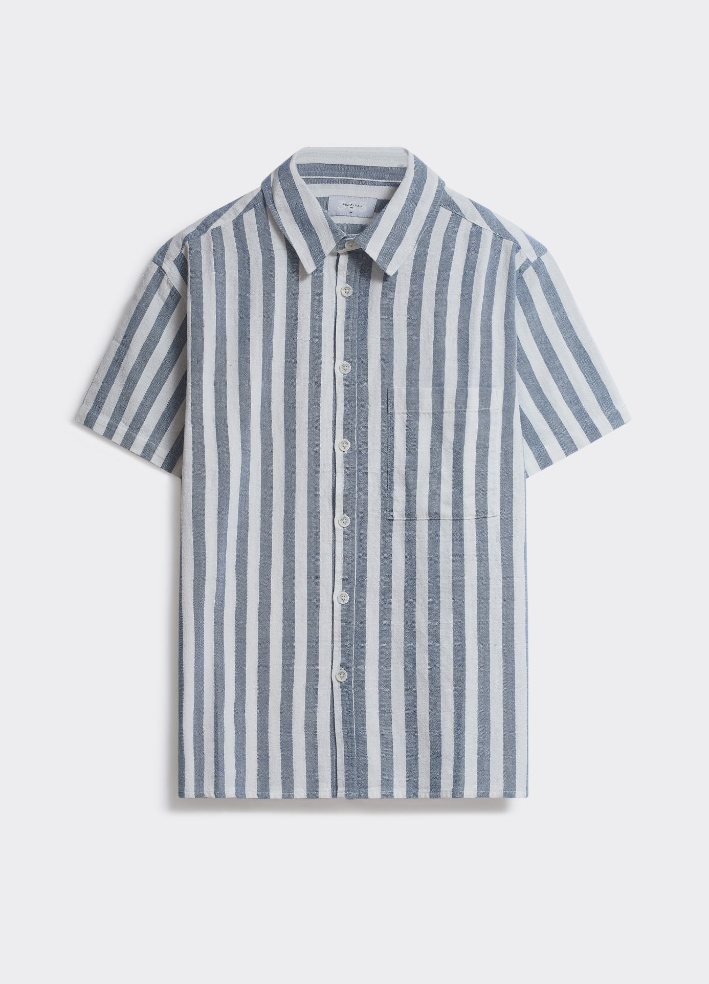 The Percival Brock Shirt in blue stripe, a short-sleeved woven shirt with vertical stripes and a chest pocket, shown flat.