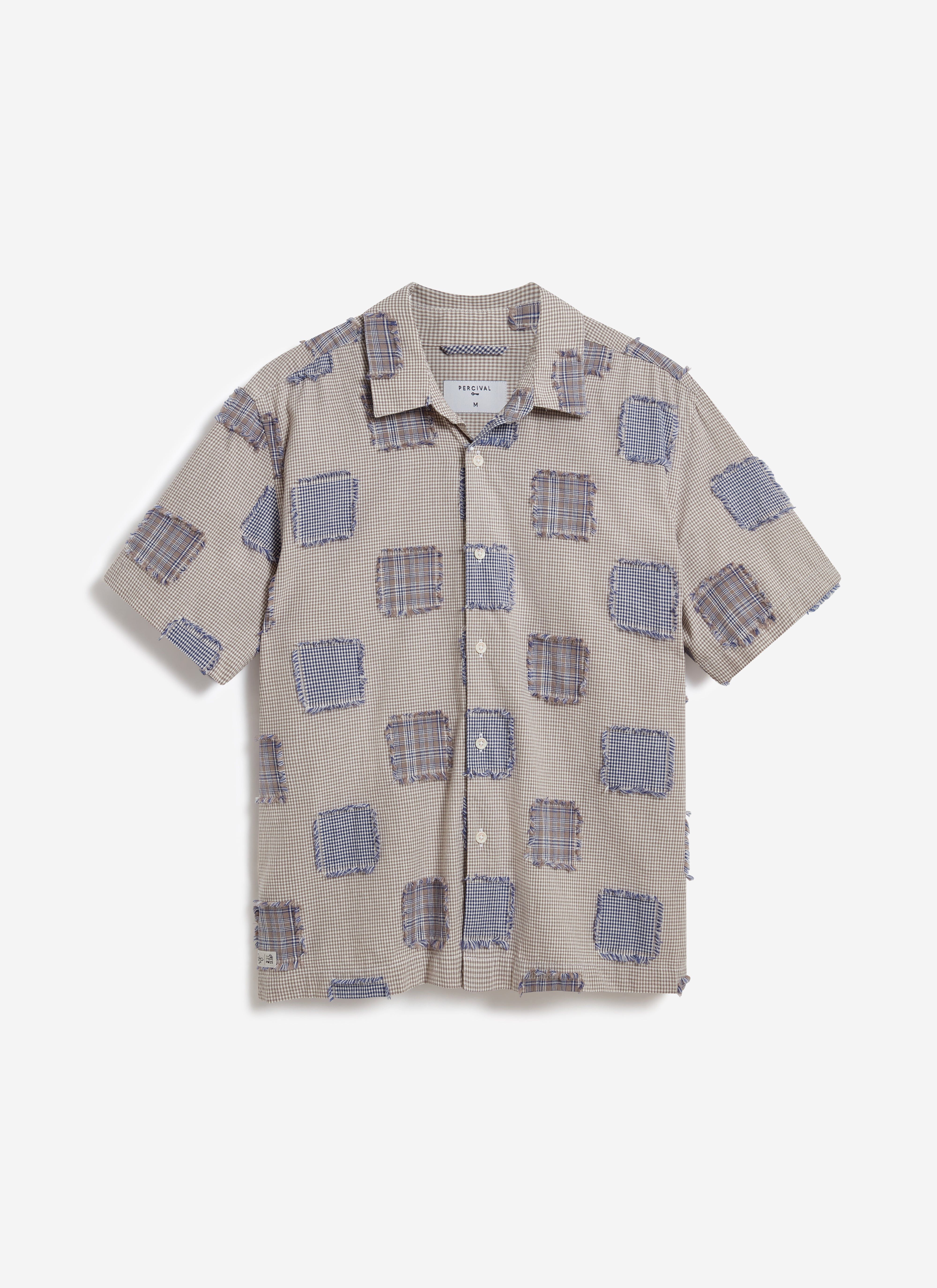 Front view of the Percival Bruno Boxy Clerk Shirt in grey, a patchwork design with frayed flannel panels on a checked base.