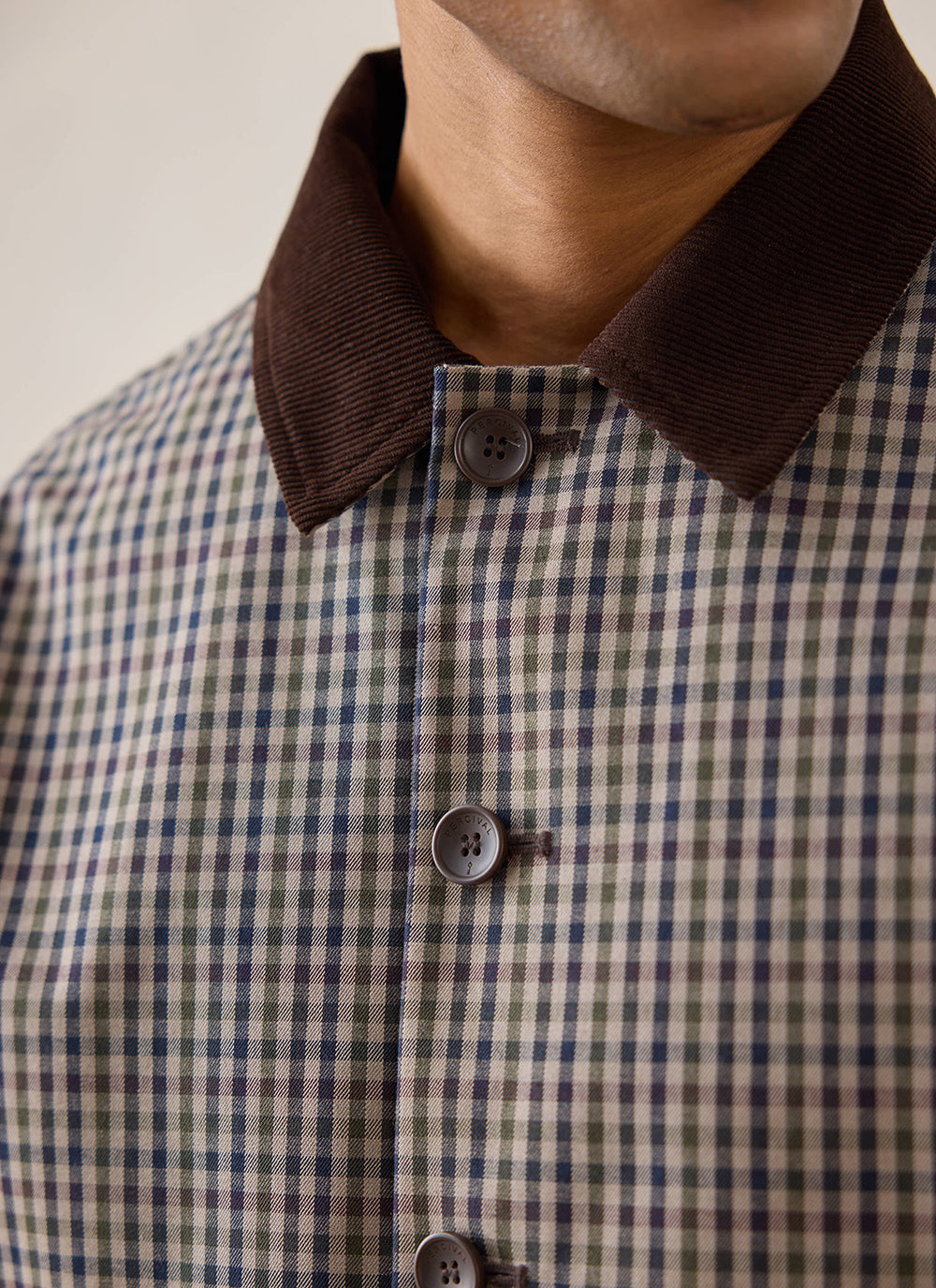 Close-up of a model wearing the Percival Watcher Check Carter Cropped Jacket, highlighting the contrast collar and buttons.