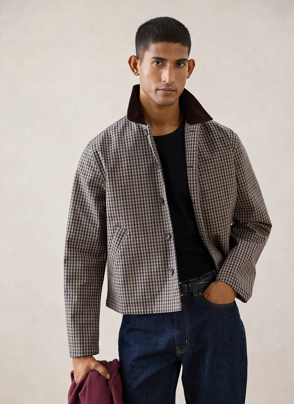 A model wears the Watcher Check Carter Cropped Jacket from Percival, over a black t-shirt and dark jeans.