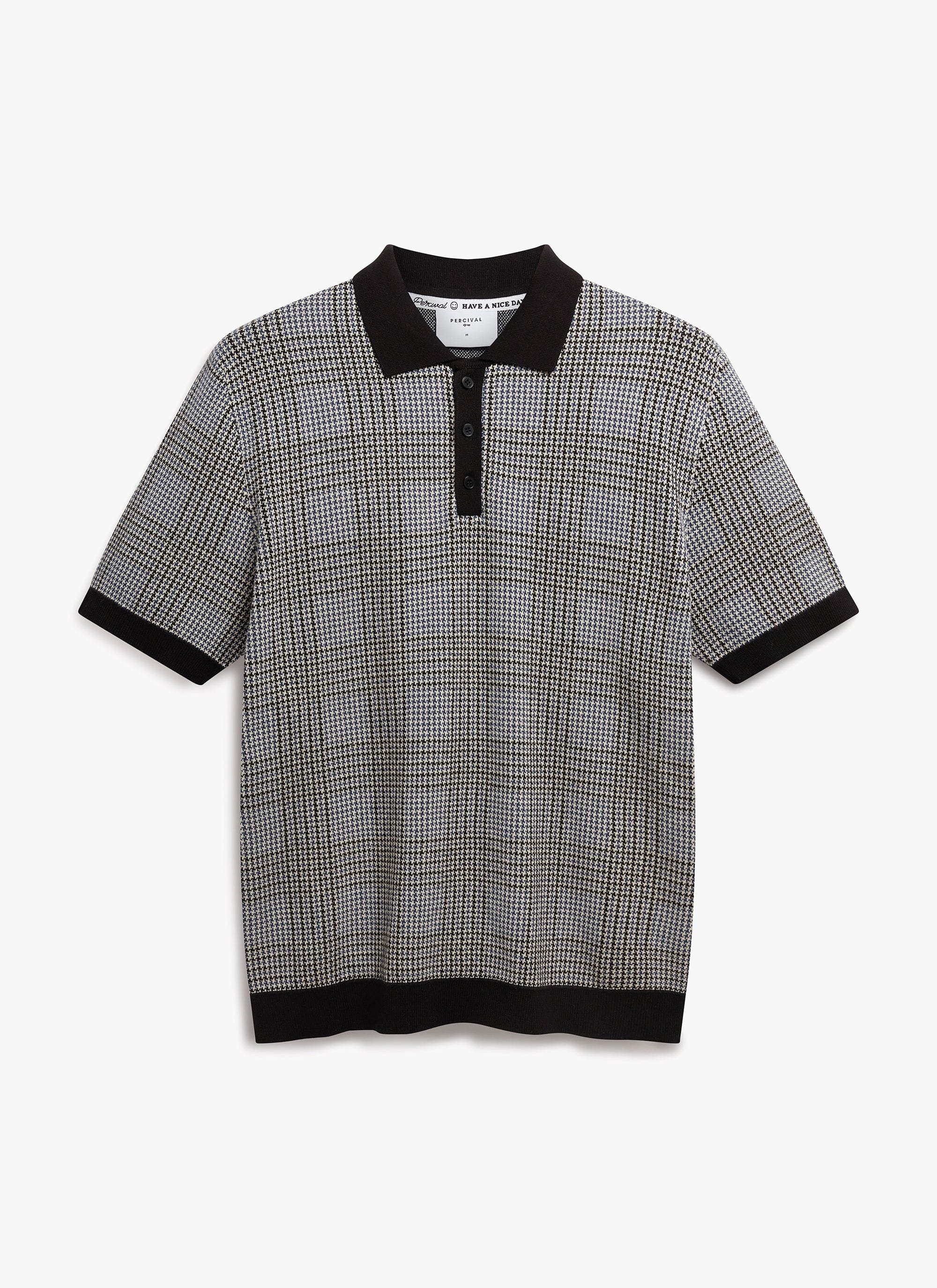 The Percival Casa Martini Knitted Polo in a navy puppytooth cotton, shown from the front against a plain background.