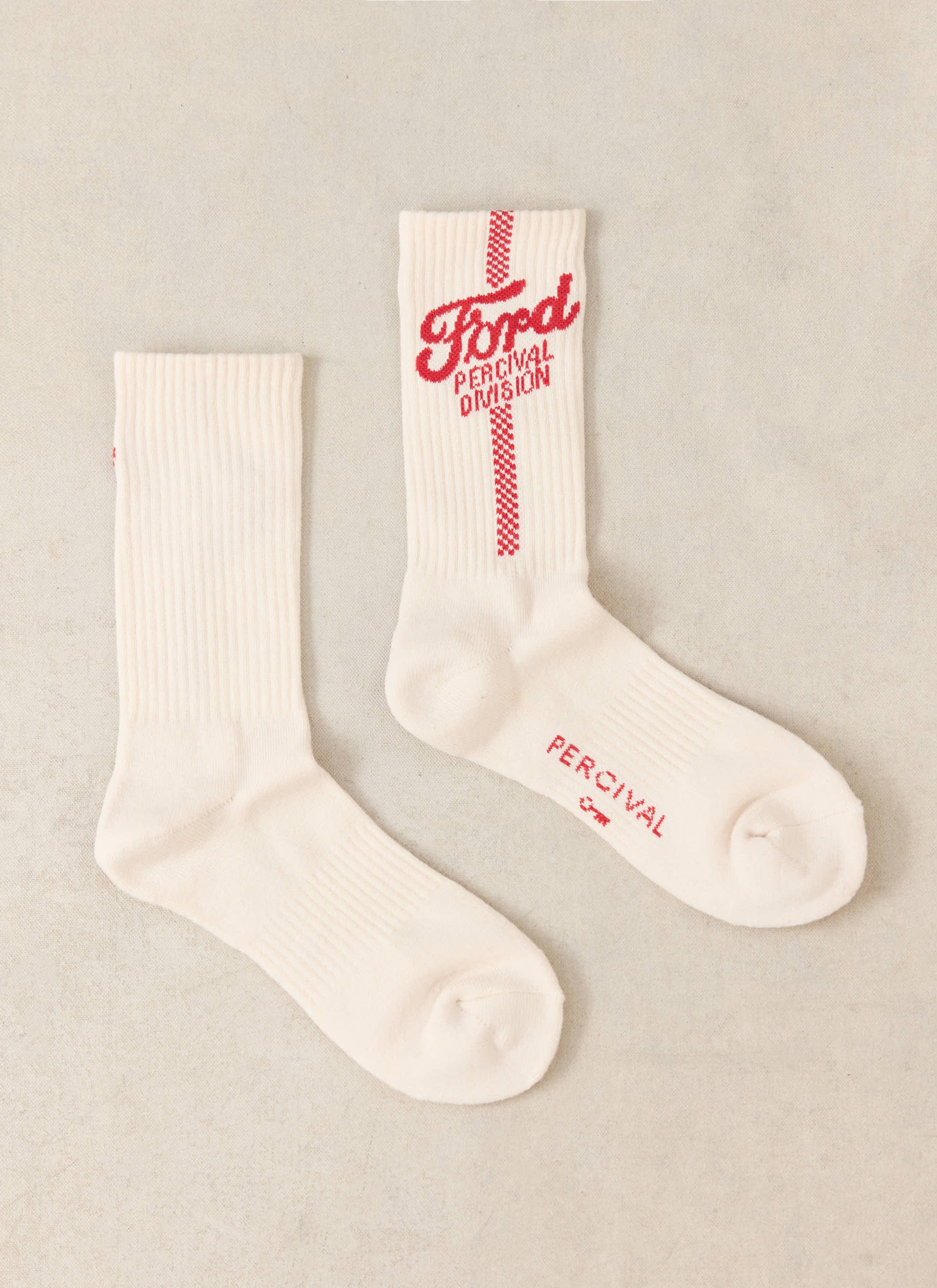 Cream Ford x Percival crew socks featuring red jacquard branding and a vertical checkered stripe in a cotton-blend.