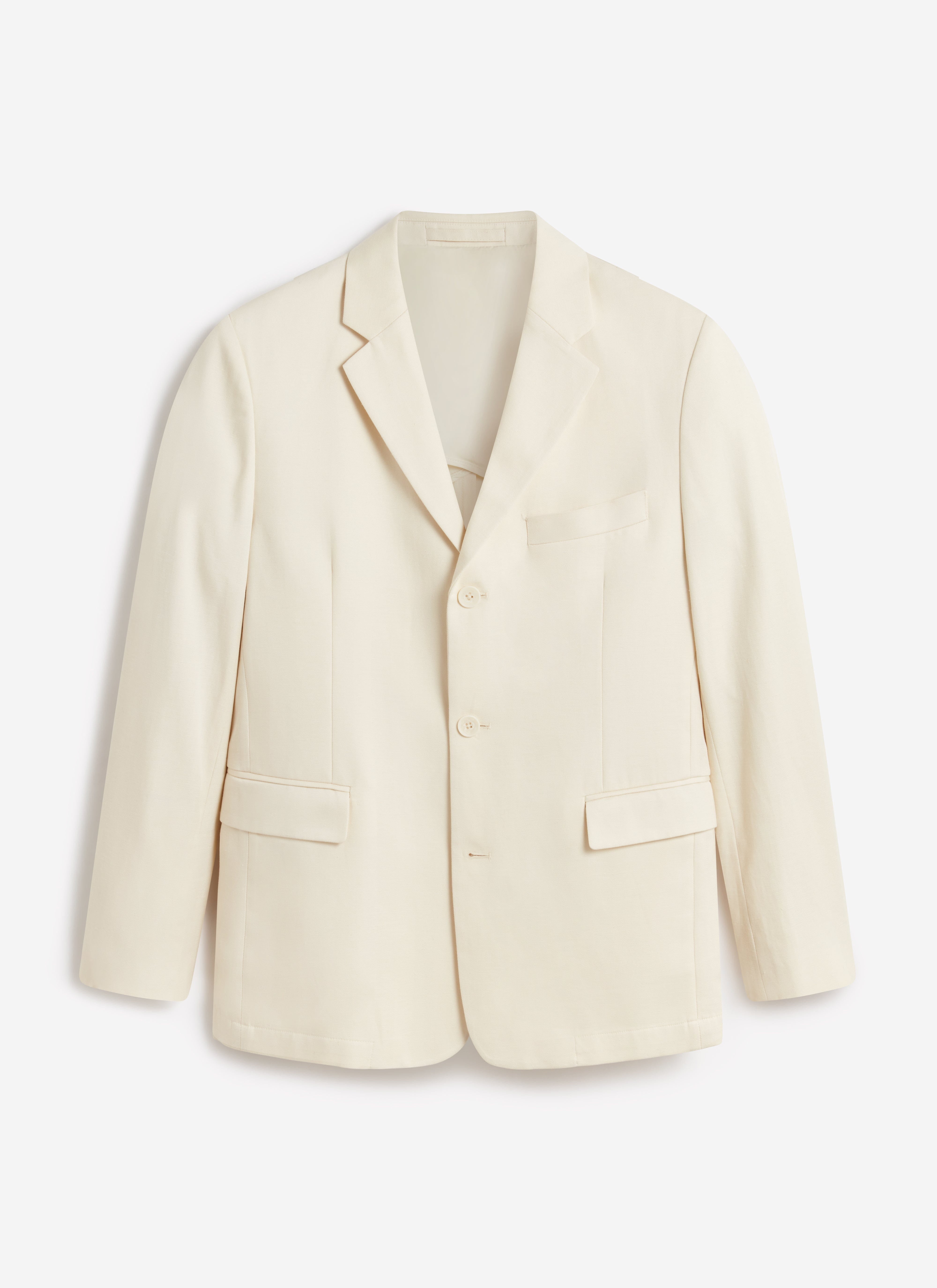 A flat lay of the Percival Clifton 3 Button Blazer. The tailored jacket is in a cream lyocell blend.