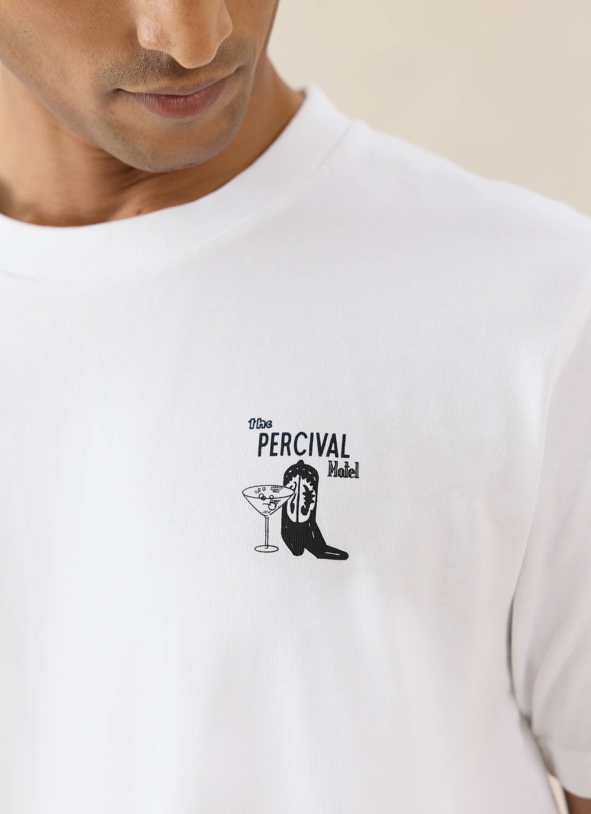 White Percival Cowboy Boot T-shirt in organic cotton, featuring a small western Americana-style graphic on the chest.