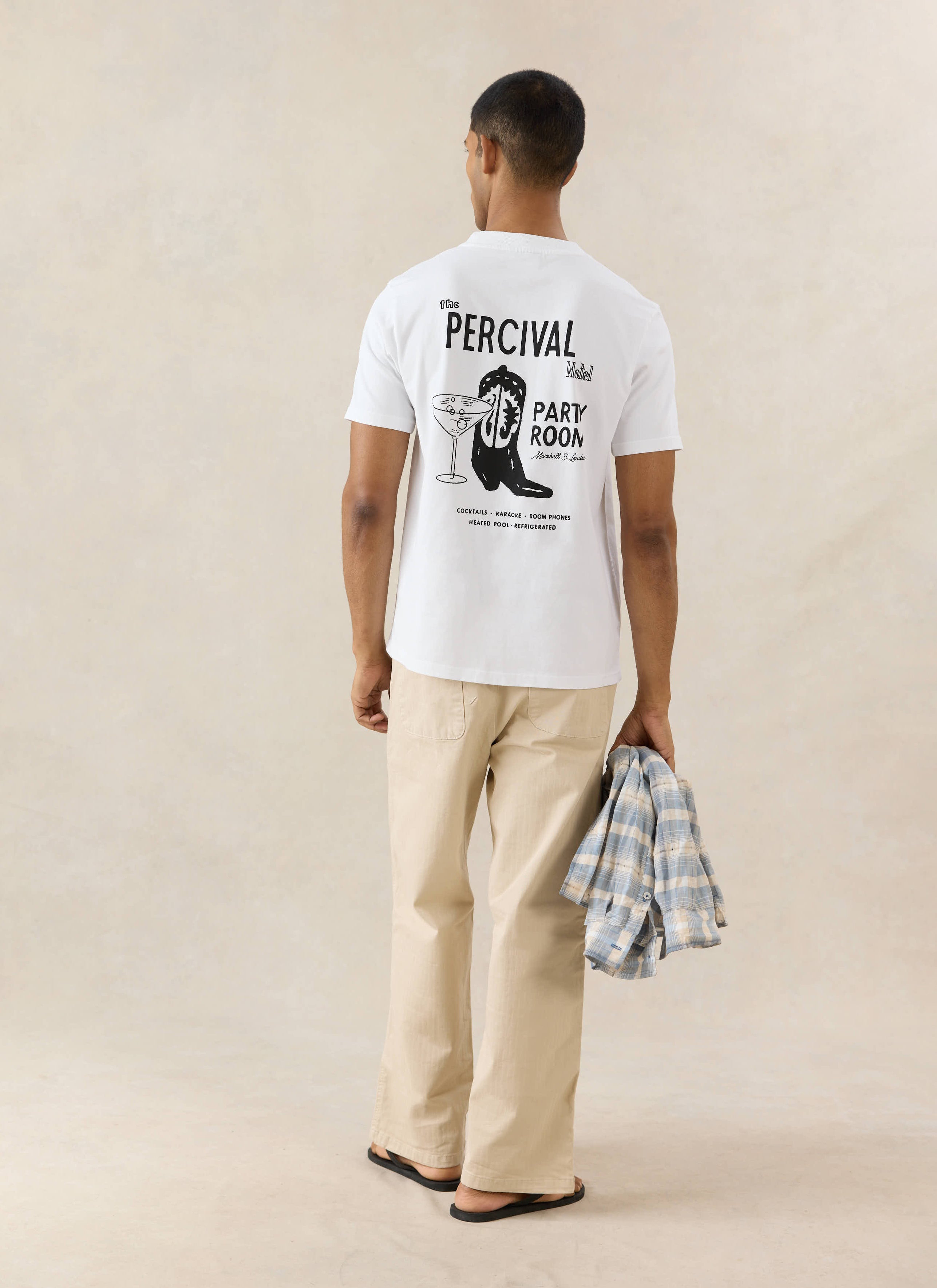 White Percival Cowboy Boot t-shirt in organic cotton, featuring a black western motel back graphic on a model.
