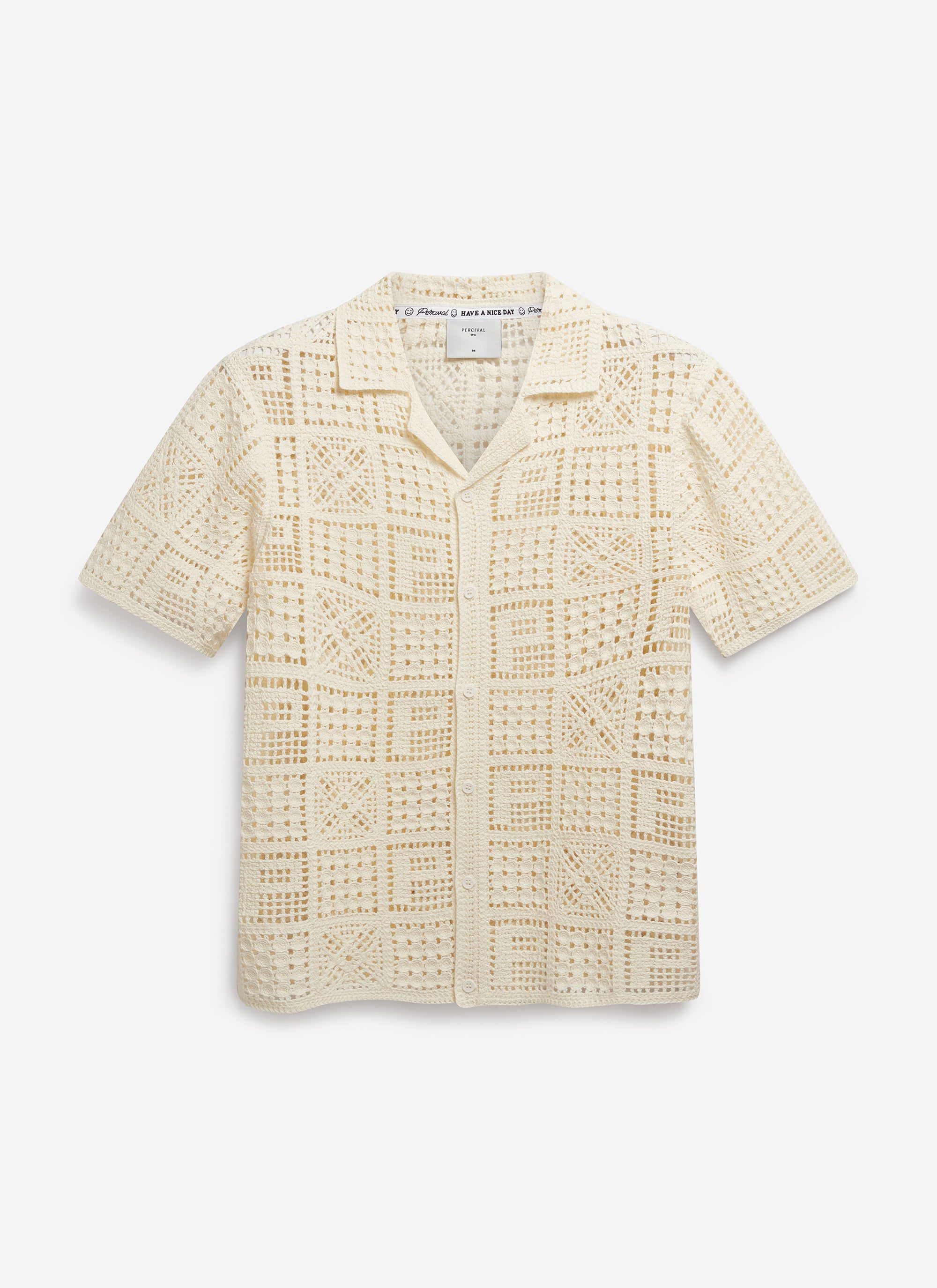 The Percival Crochet Groundsman Shirt in ecru, a short-sleeve cotton shirt with an intricate geometric crochet pattern.