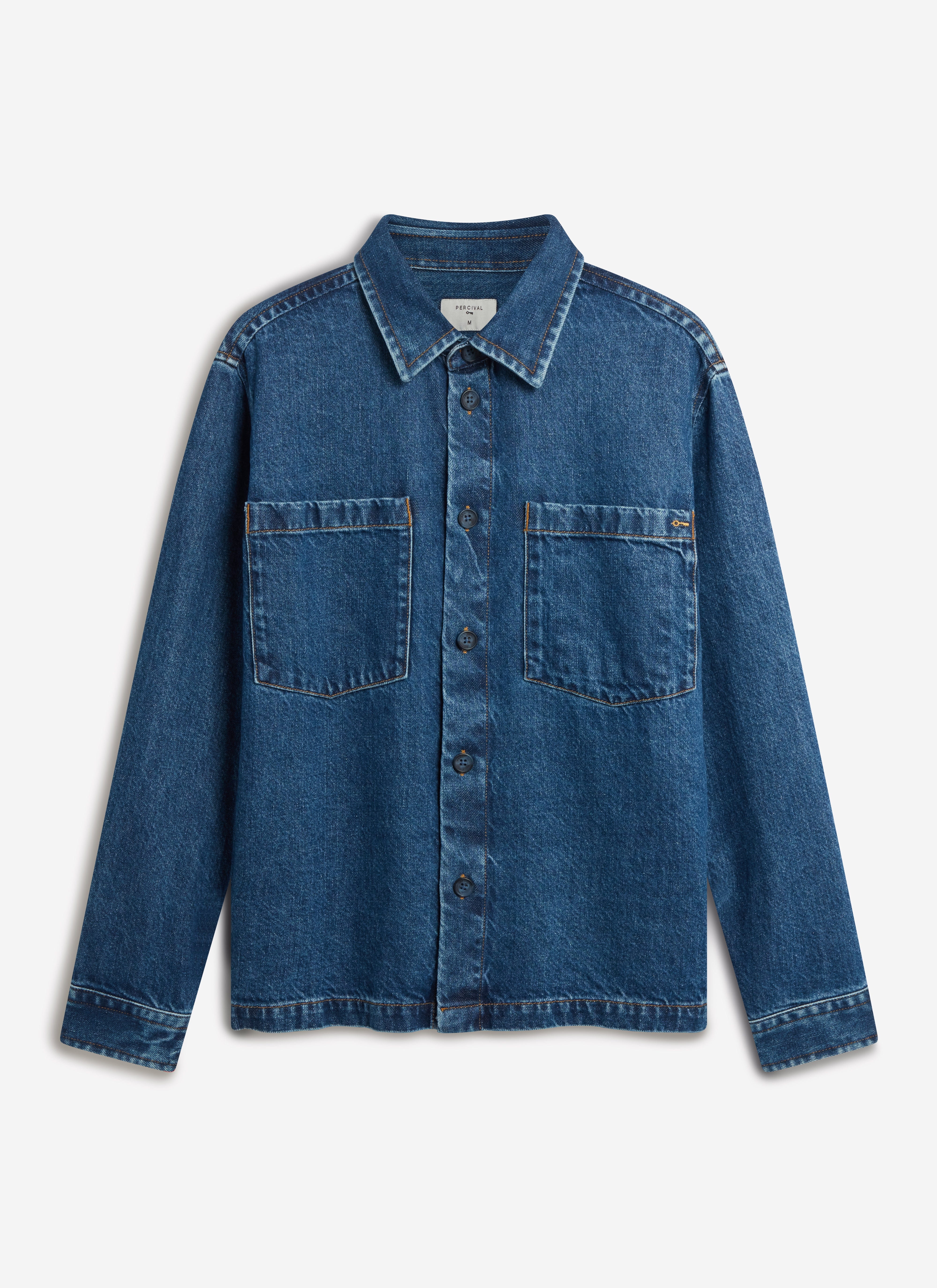 A flat lay of the Percival Denim Heavyweight Overshirt in mid-wash blue, showing the button-down front and chest pockets.