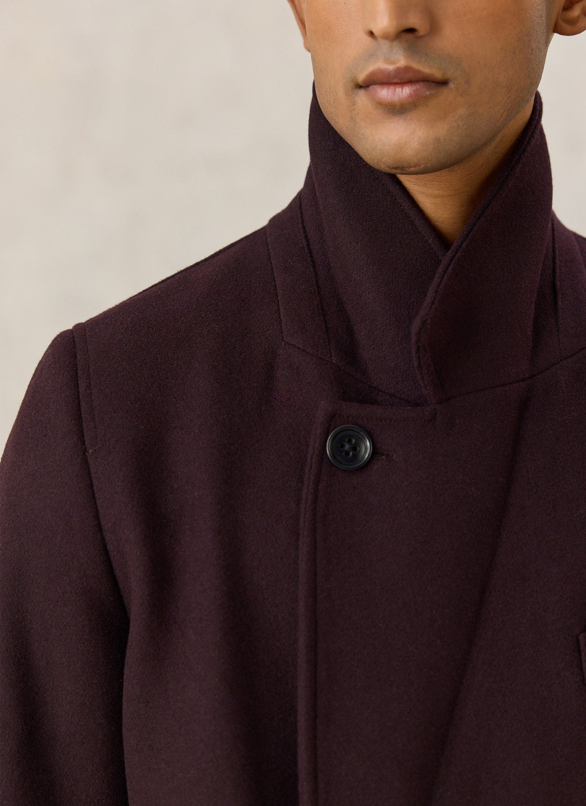 A close-up of the Percival dark brown wool-blend double-breasted overcoat, highlighting the wide lapels and button collar.