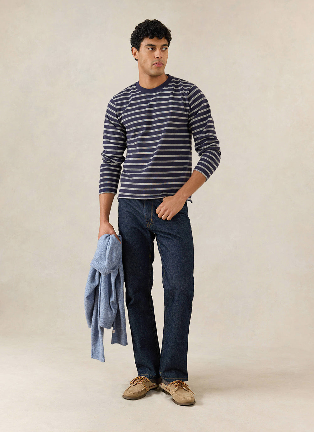 A model wears the Percival navy stripe Arlo long sleeve Breton T-shirt with dark trousers and shoes.