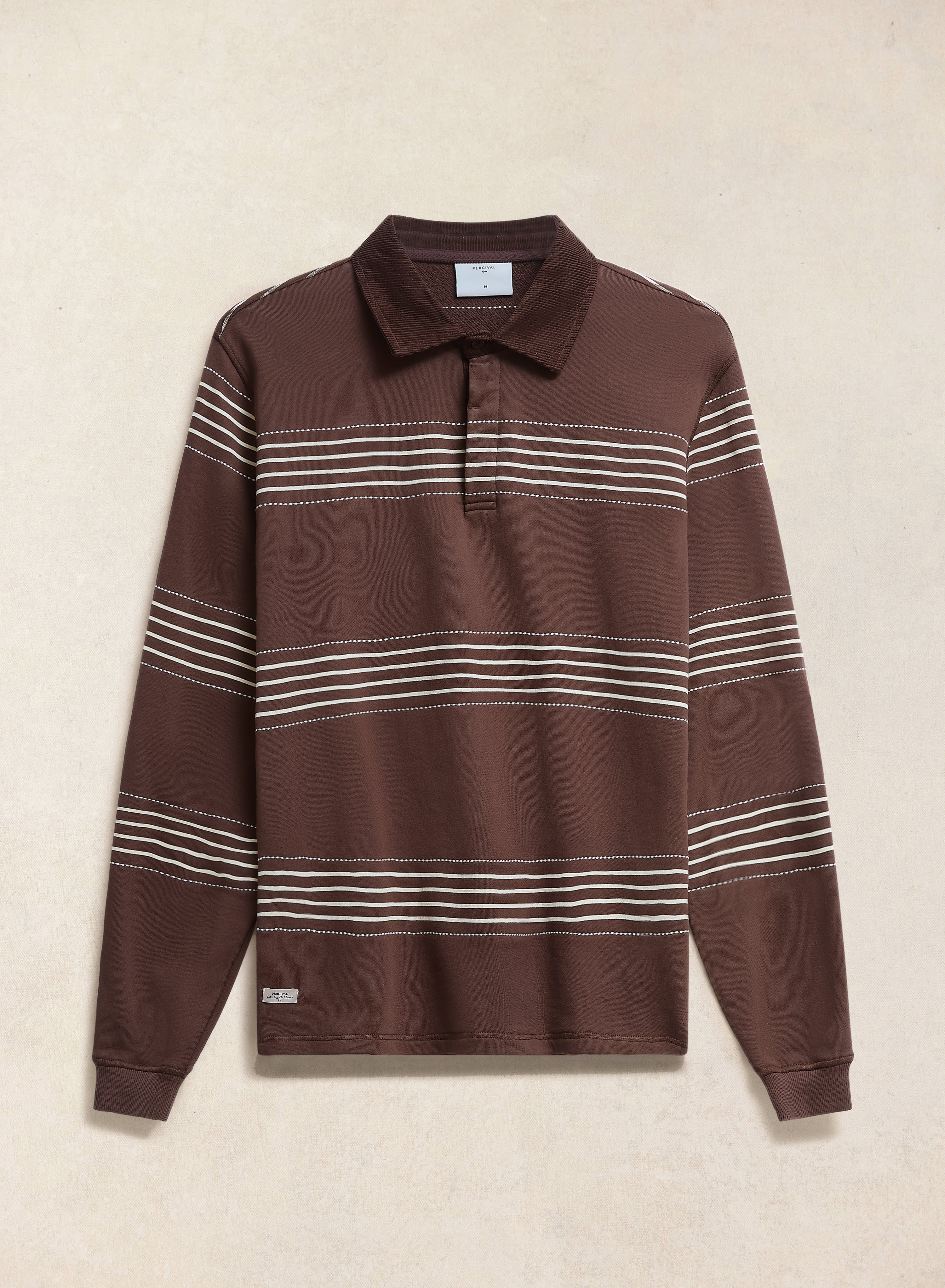 The Percival Editor Striped Rugby Polo in espresso brown cotton with a cord collar and white stripes, shown flat.