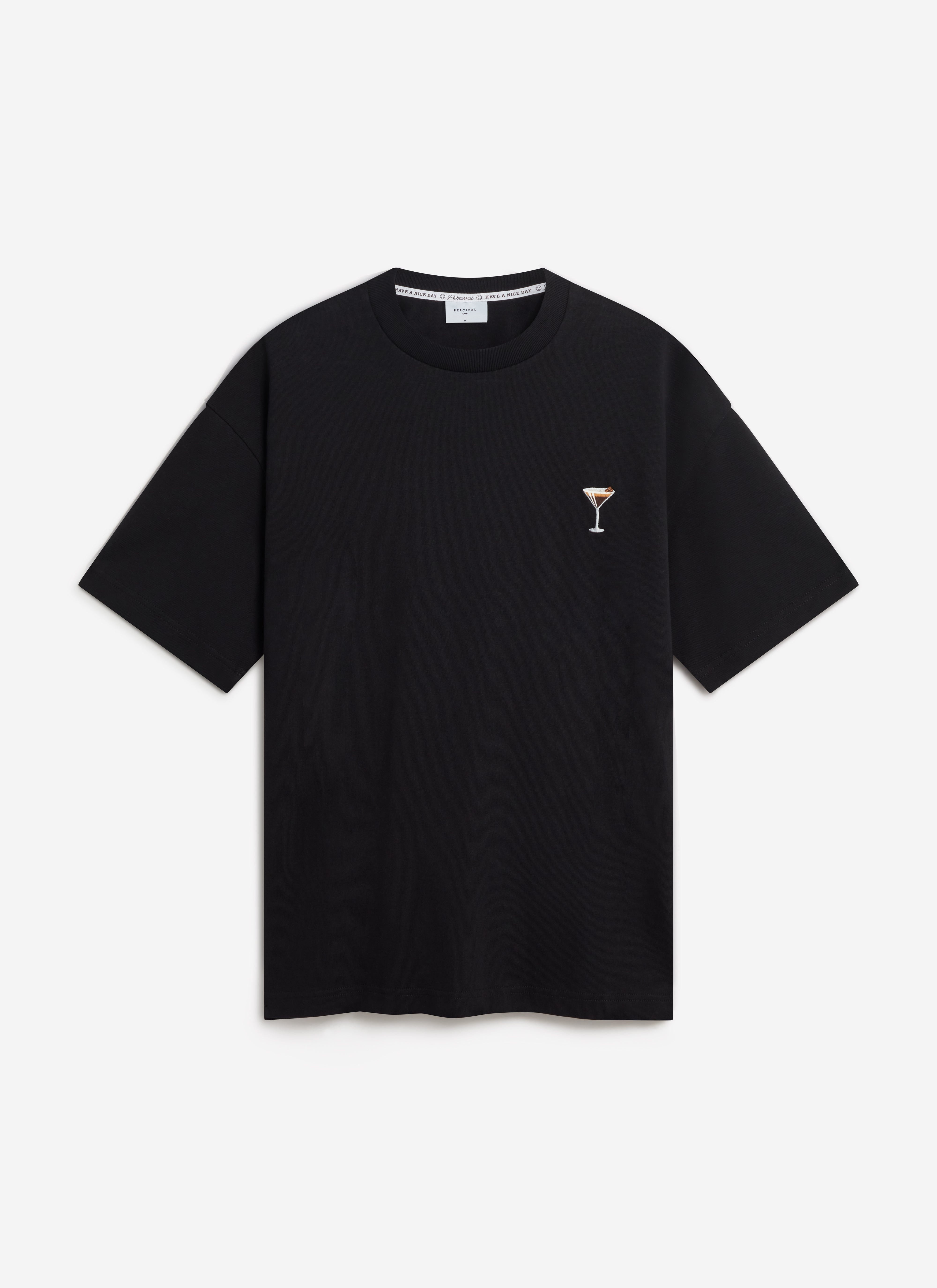 A flat lay of the Percival Espresso Martini Oversized T-Shirt in black, showing the cocktail embroidery on the chest.