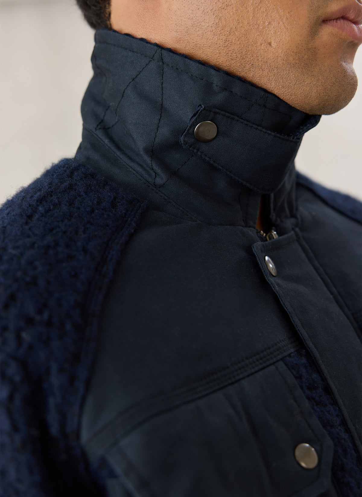 Close-up of the Percival navy Fletcher utility jacket highlighting its mixed wool-blend fleece and waxed panels.