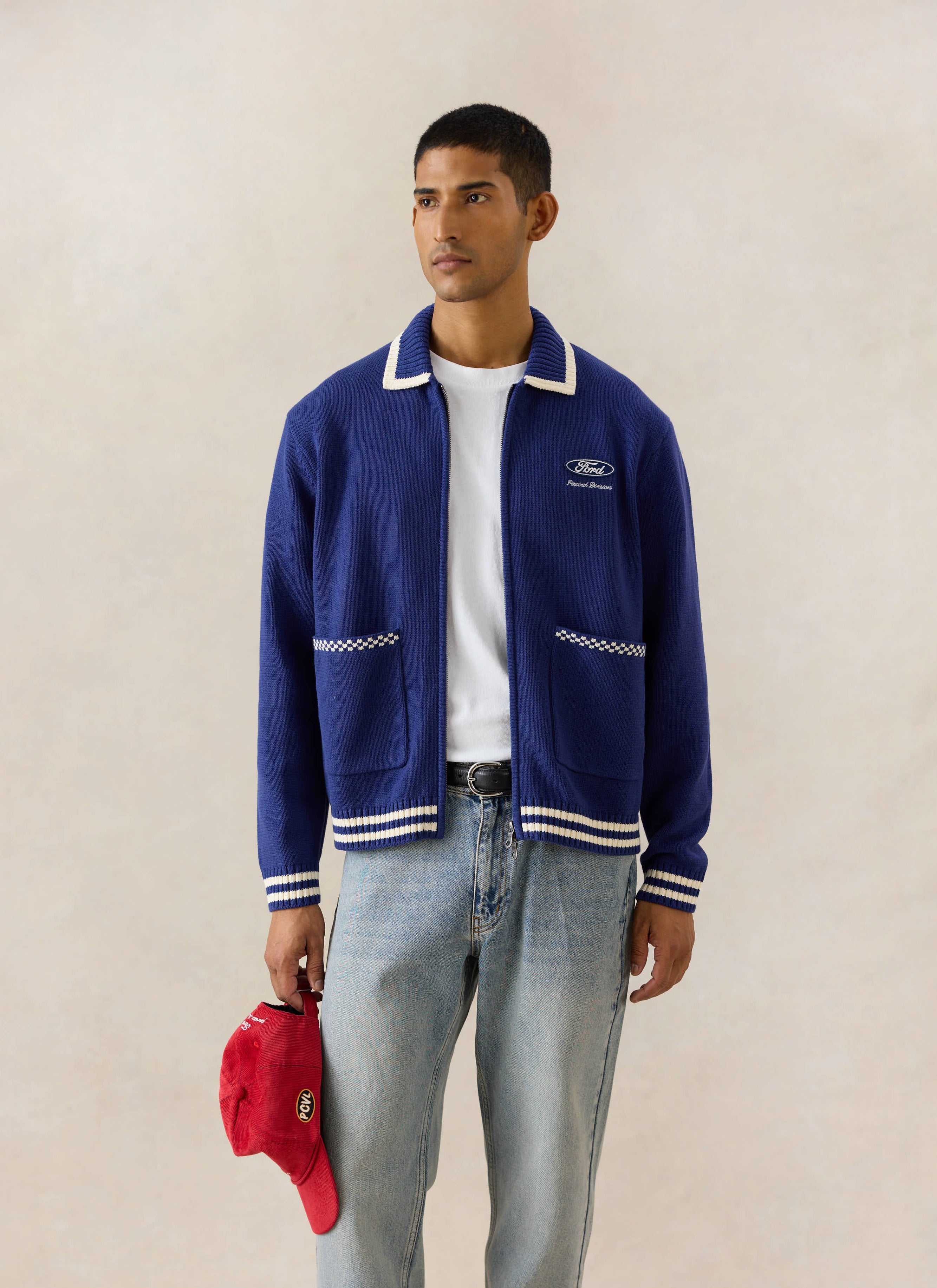 Blue Percival x Ford Gardner knitted zip cardigan with white trim, styled with light wash heritage denim jeans.