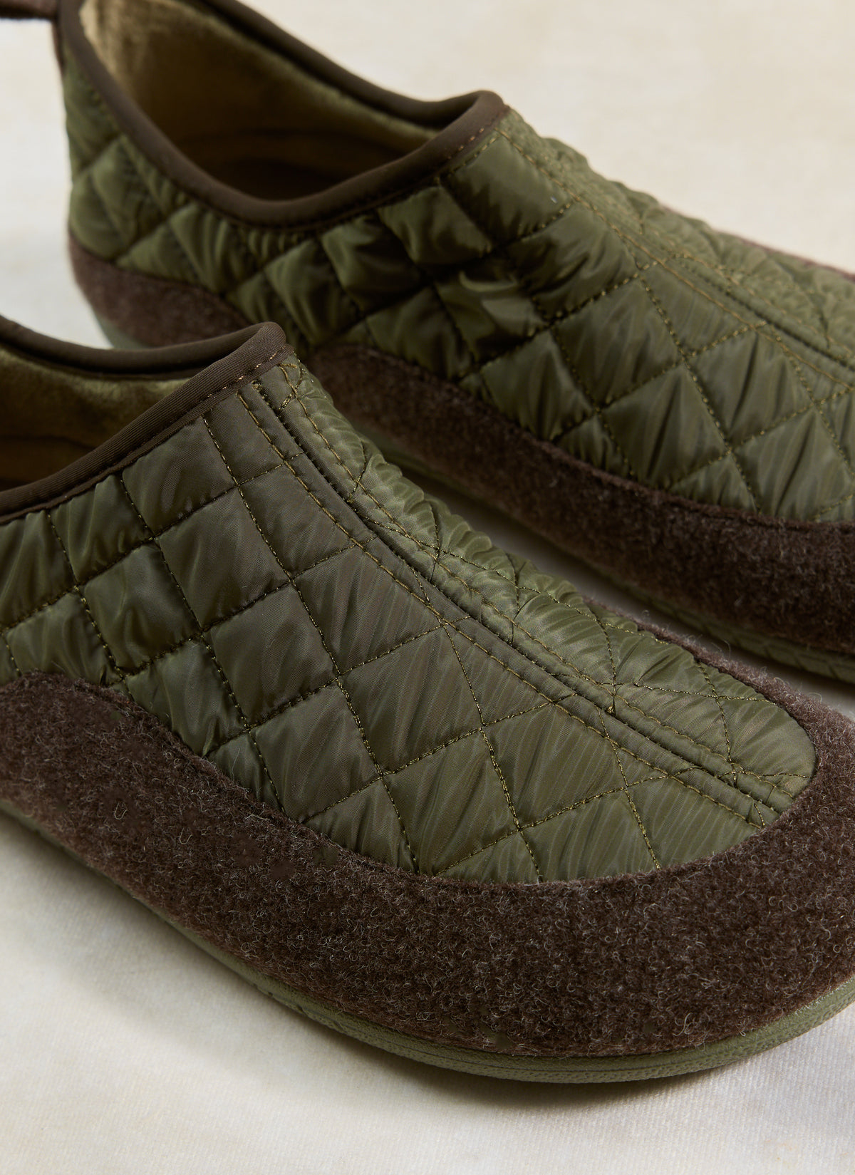 Close-up of the Percival Gurus Valencia Classic Homeshoe in khaki, showing its quilted nylon upper and felt foxing tape.
