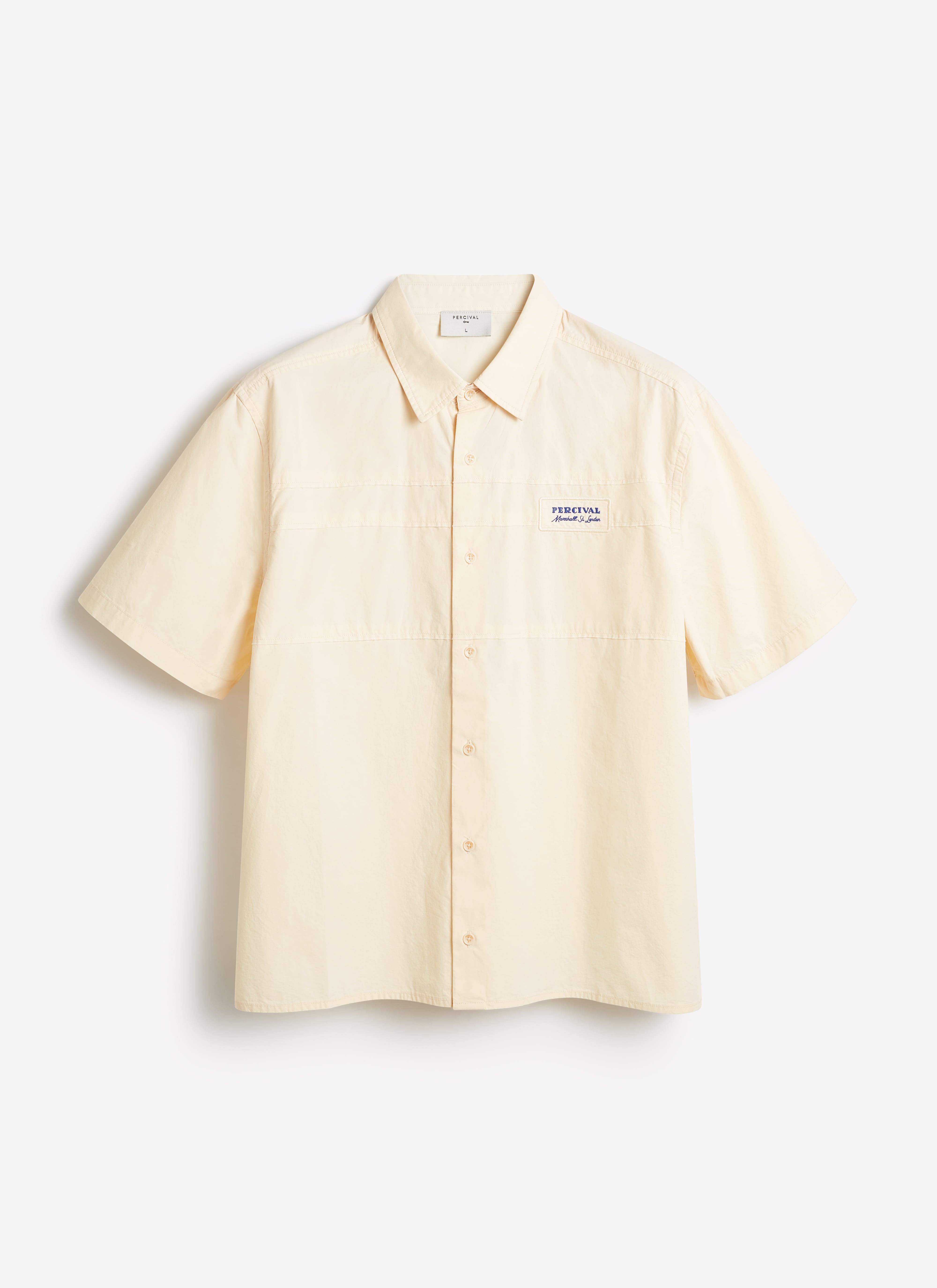 Percival Harlow Boxy Shirt in ecru cream cotton, featuring a short-sleeve relaxed fit and embroidered chest badge.