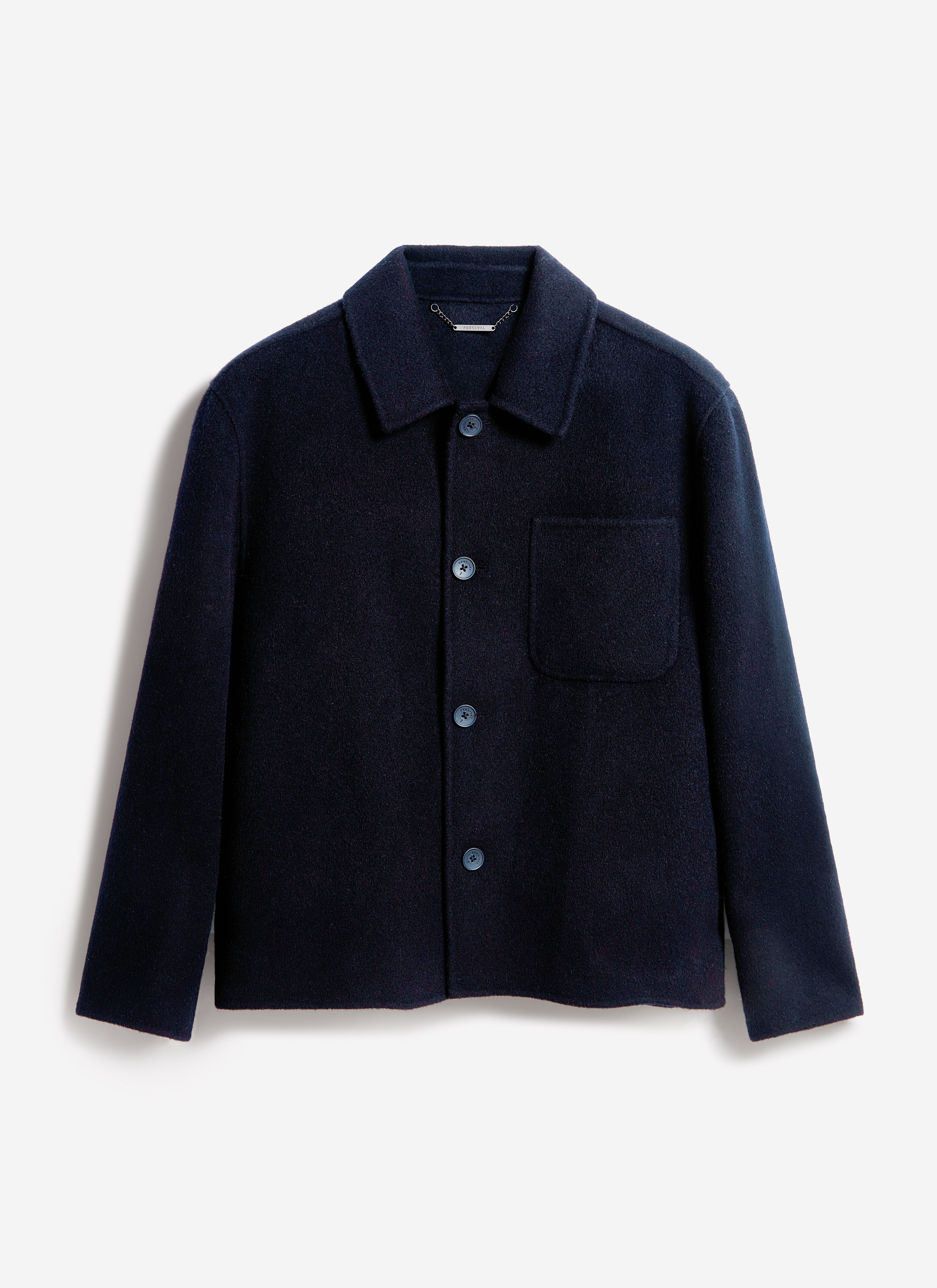 A flat lay photograph of the navy Heavy Wool Overshirt by Percival, showcasing its textured fabric and classic design.