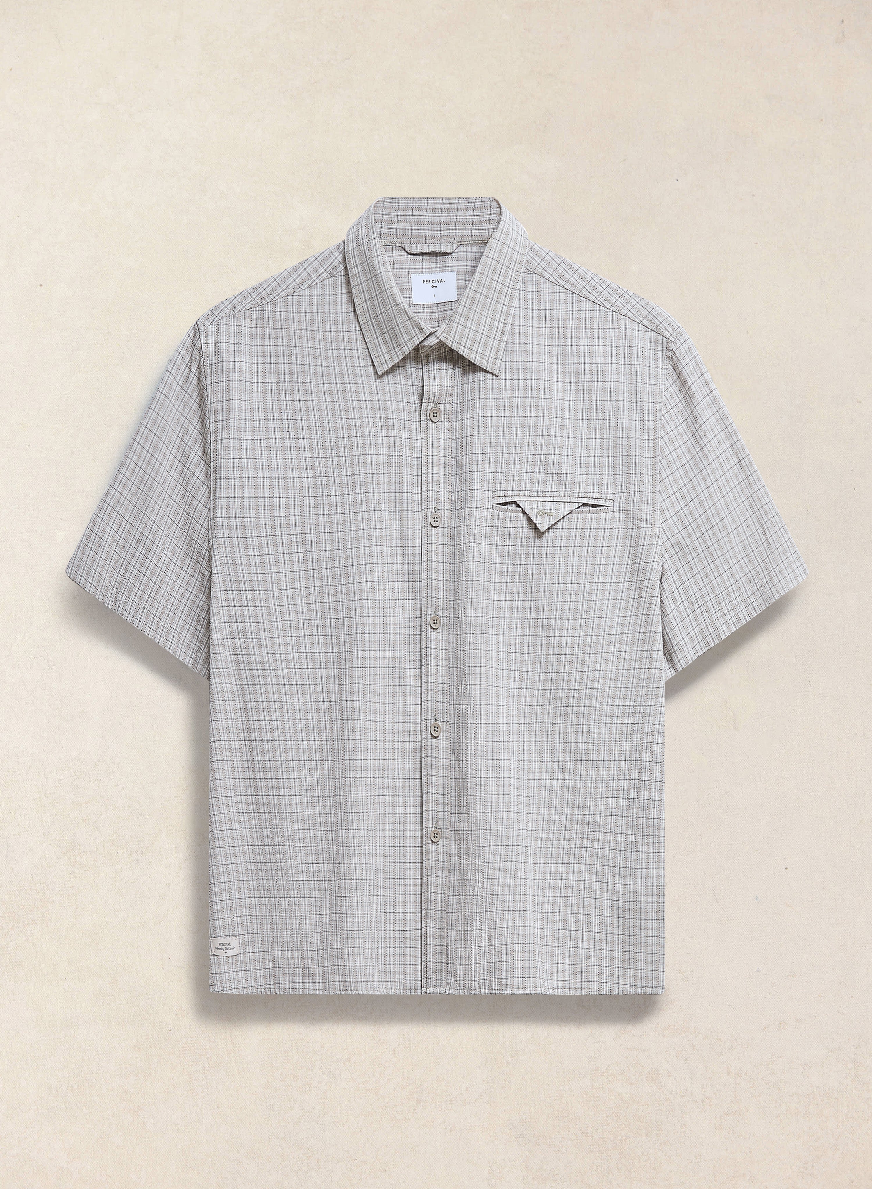 The Percival Hinsley boxy short sleeve shirt in cream check cotton, featuring a unique geometric chest pocket.