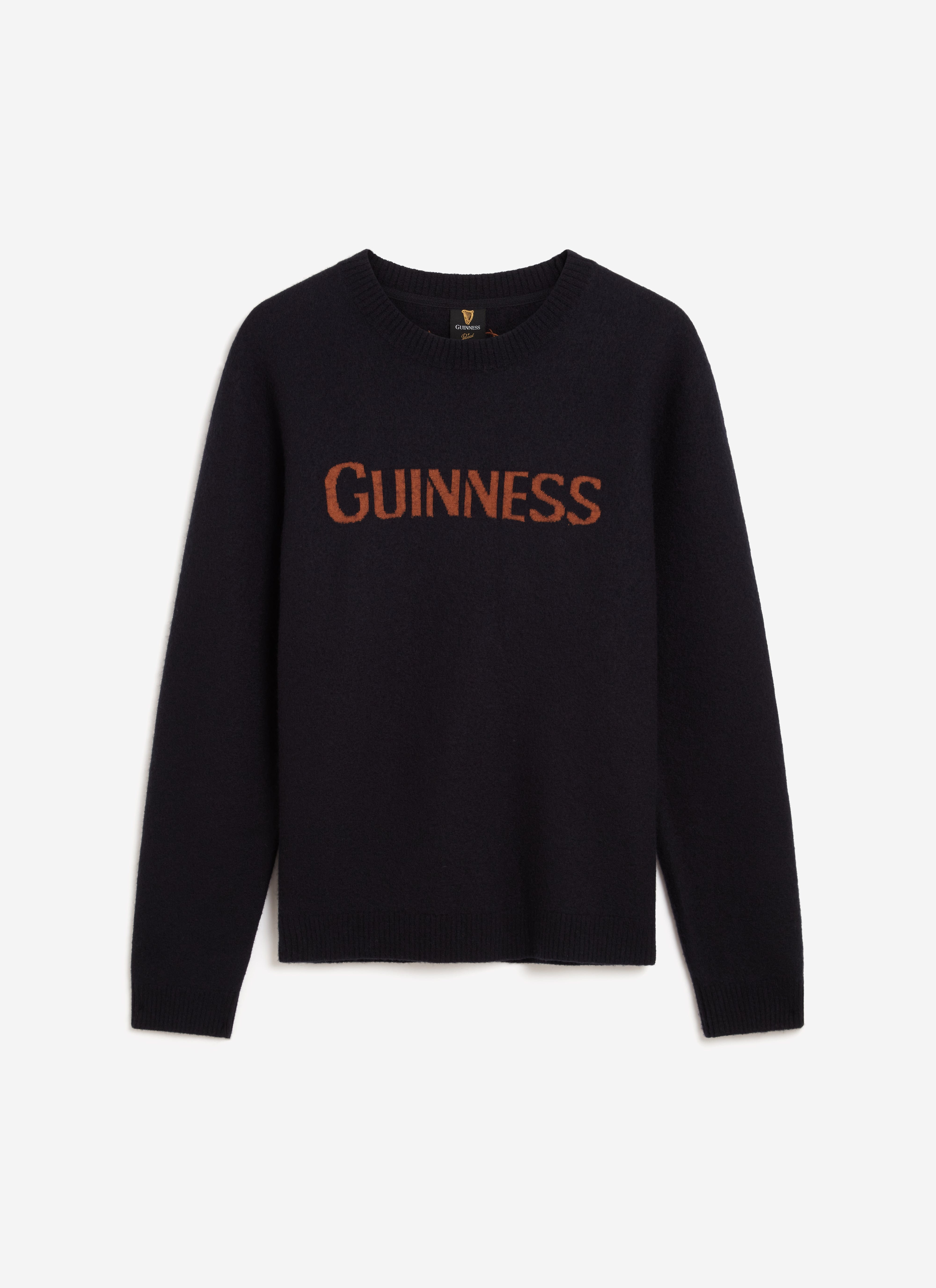 The Guinness x Percival navy merino wool jumper laid flat, showcasing the chocolate jacquard logo across the chest.