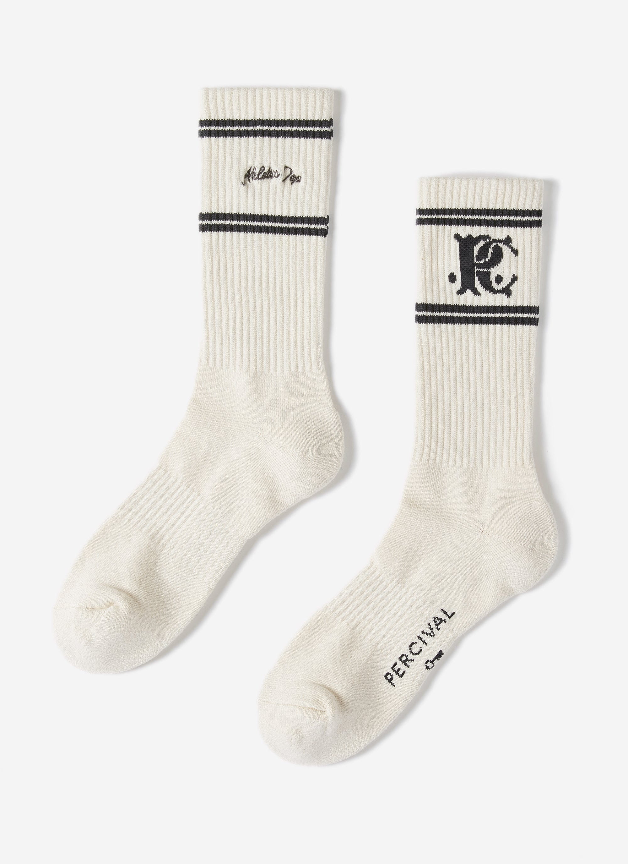 A pair of the Champion x Percival jacquard socks in white, detailed with black stripes and collaborative branding.
