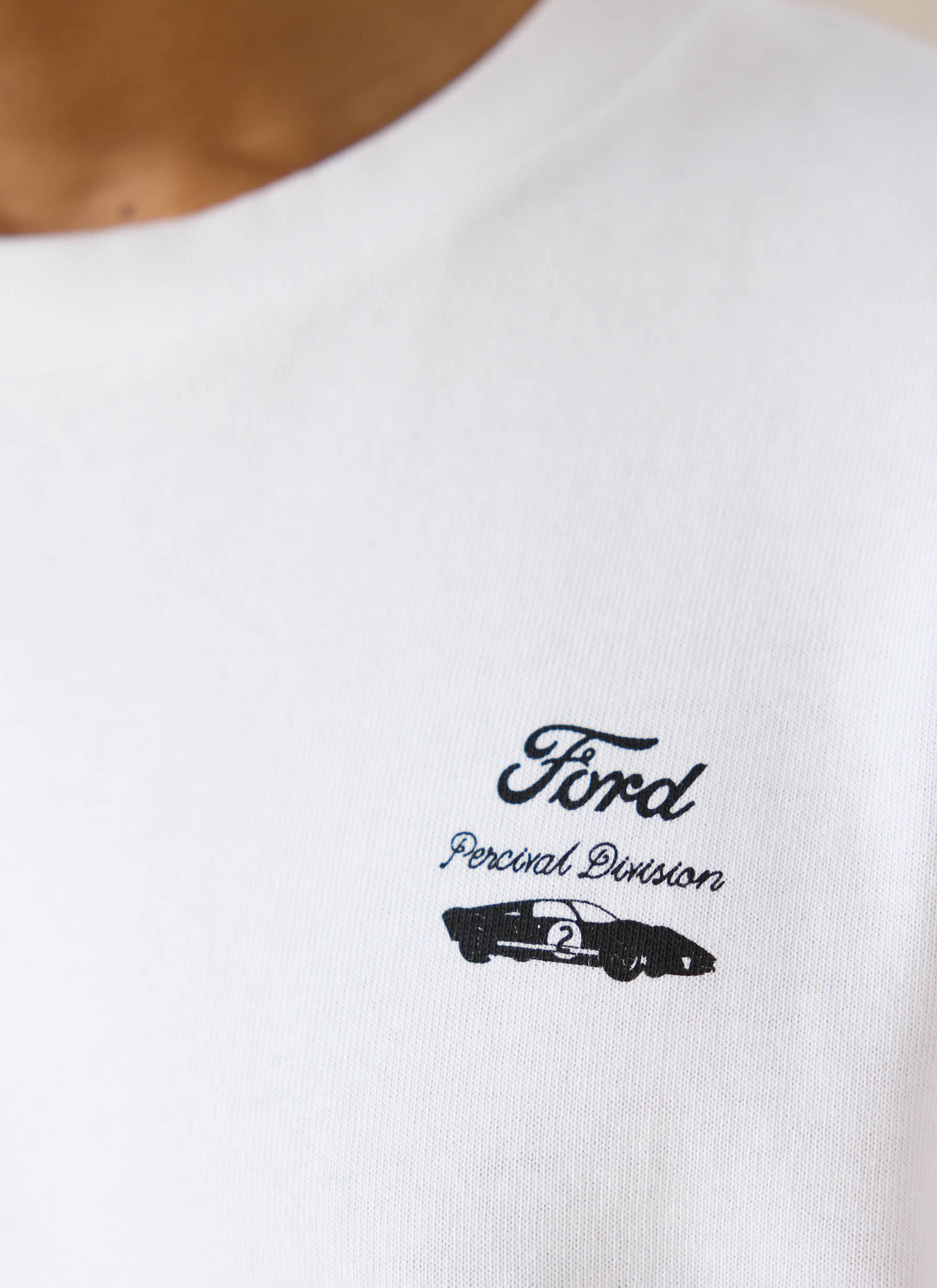 Close-up of the white Ford x Percival Le Mans T-shirt, showing the vintage racing chest graphic on organic cotton.
