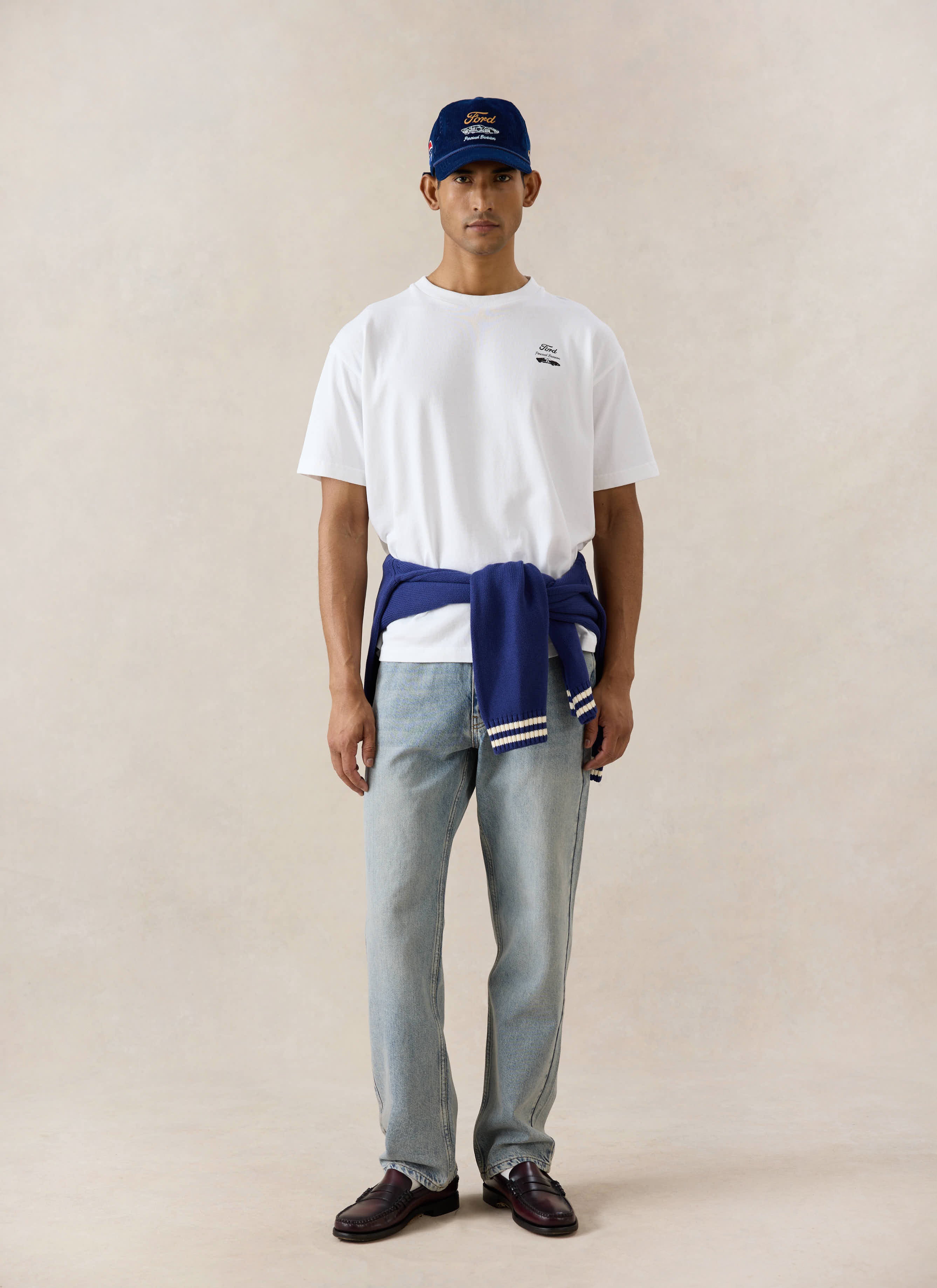 White Ford x Percival Le Mans oversized t-shirt styled with Percival straight leg jeans and a navy Ford collection cap.