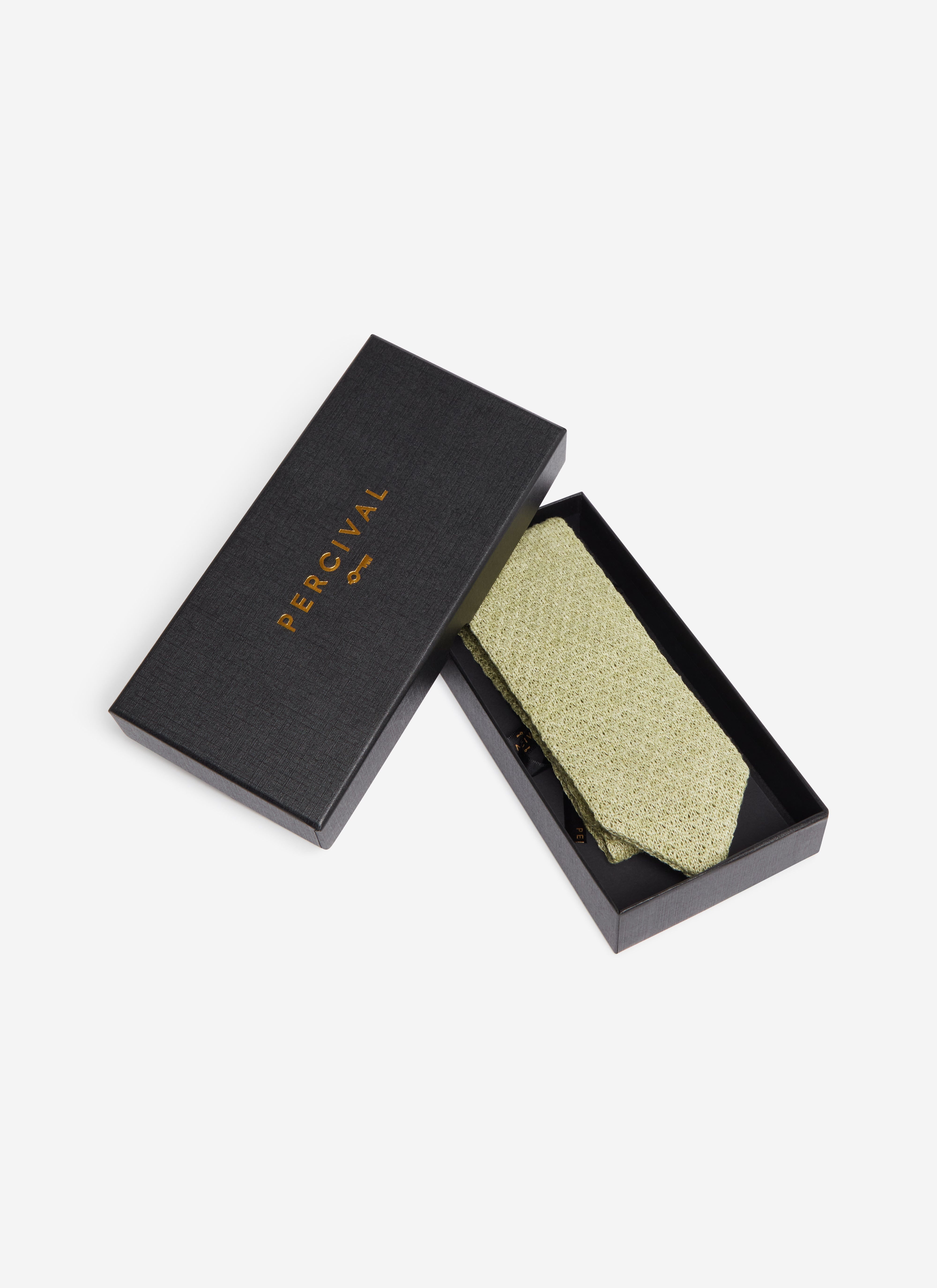 The Percival Linen Tie in Forest Marl, folded neatly inside its black branded presentation box on a white background.
