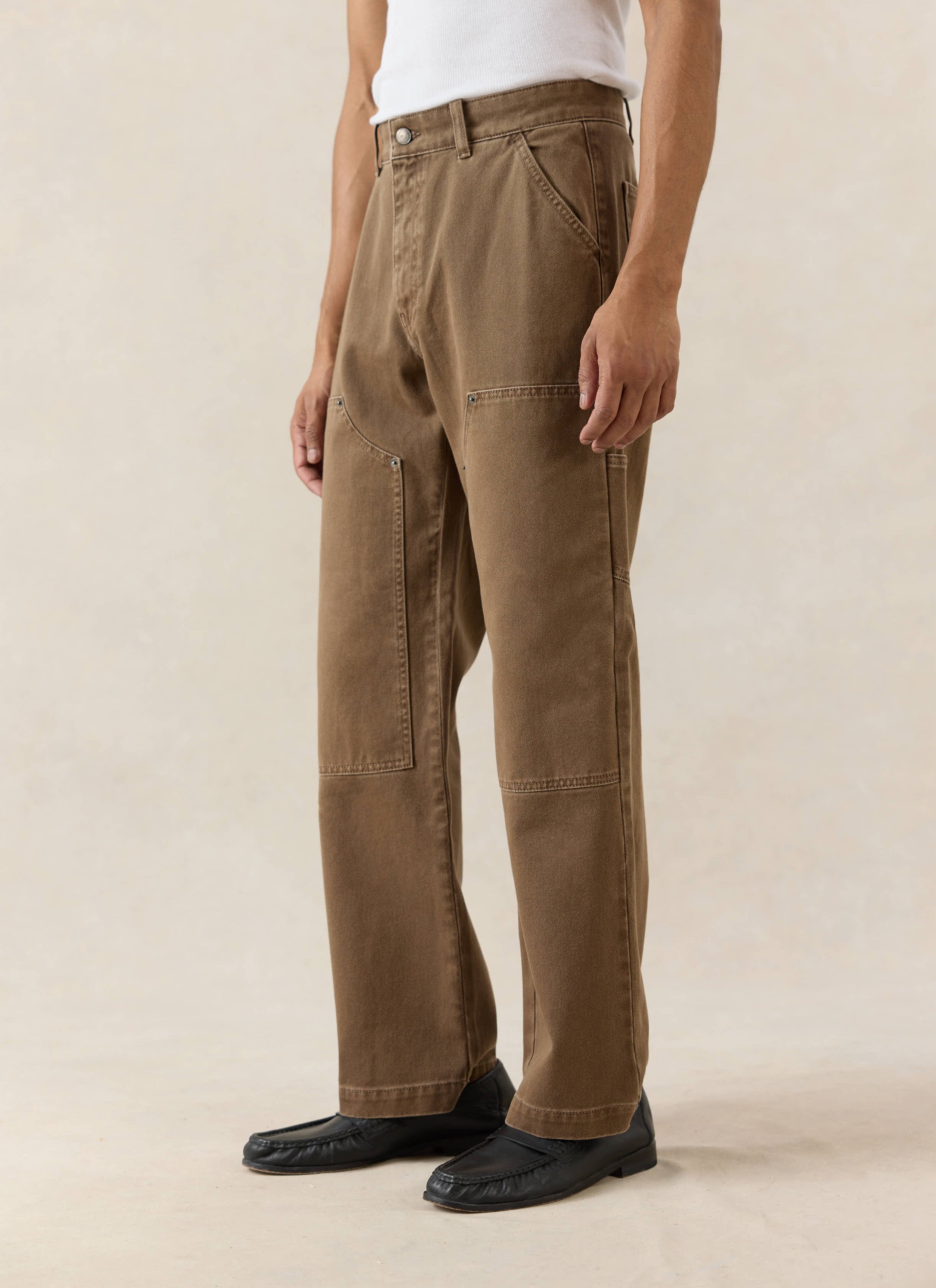 Mocha brown Lucas Carpenter trousers from Percival, featuring a straight-leg cotton fit and knee patch details.