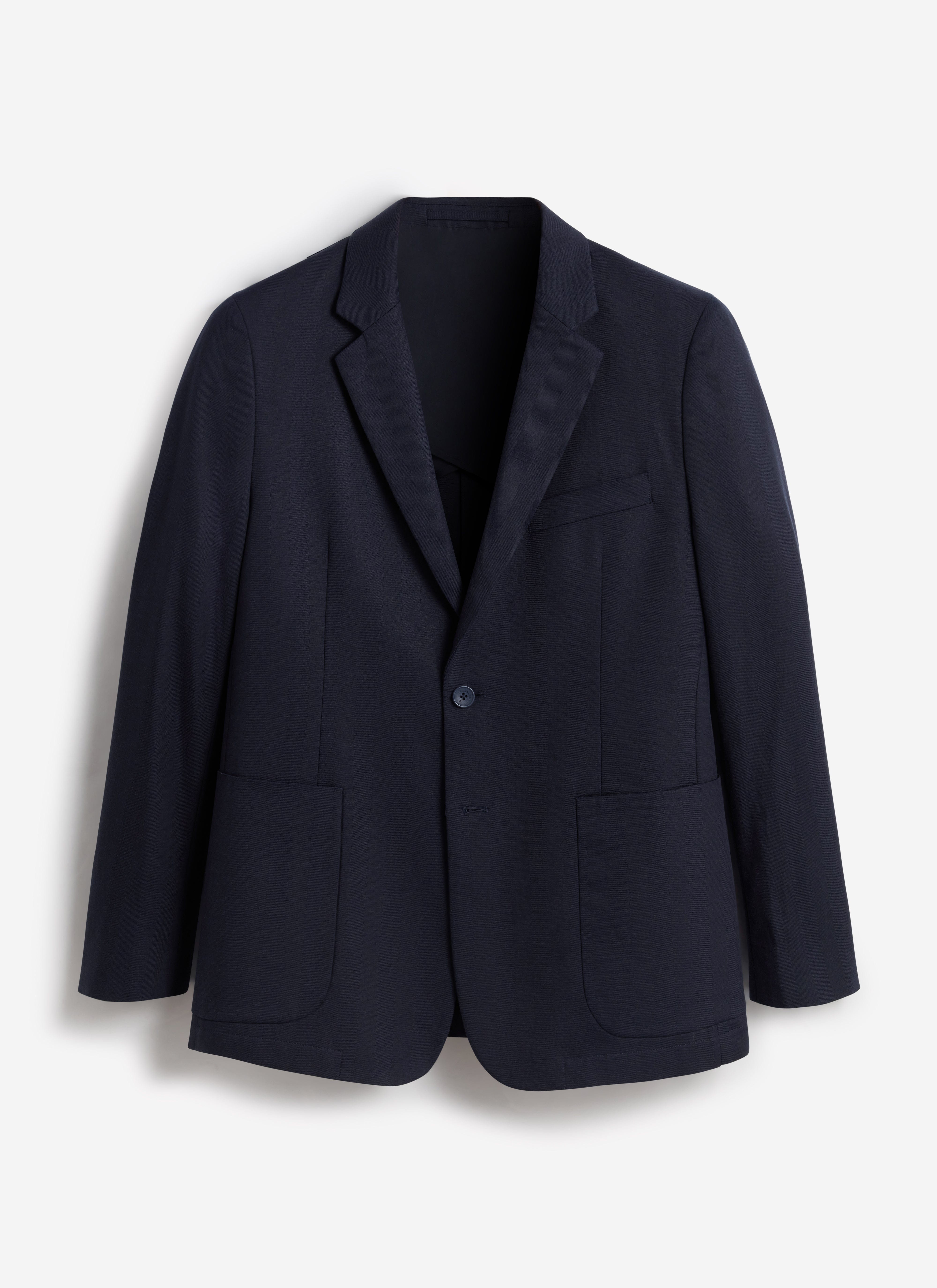 A flat lay of the Percival Lyocell Regular Blazer in navy, showing its single button closure and large patch pockets.