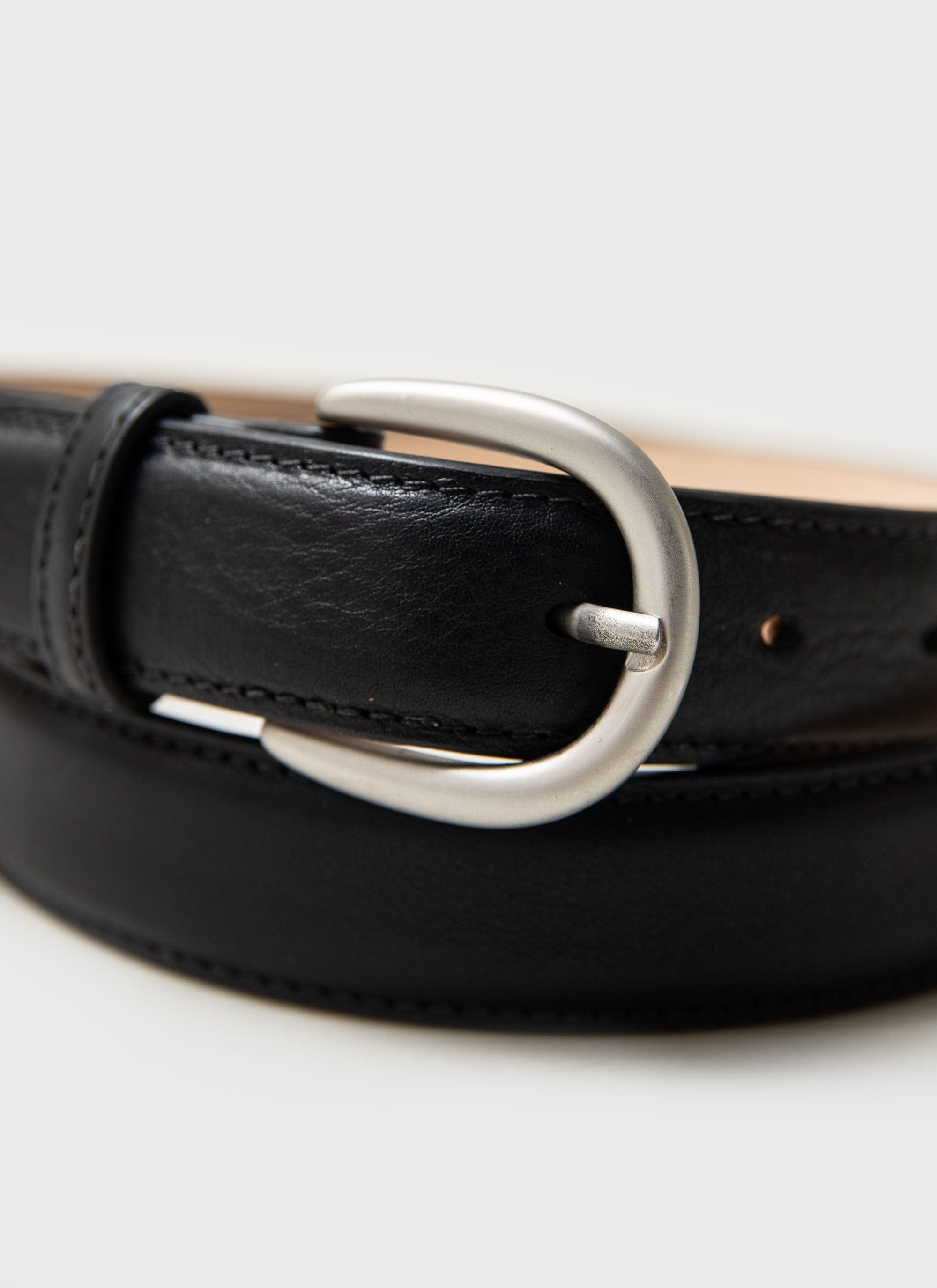 A close-up of the Percival Men's Leather Dress Belt in black, highlighting the classic silver buckle.