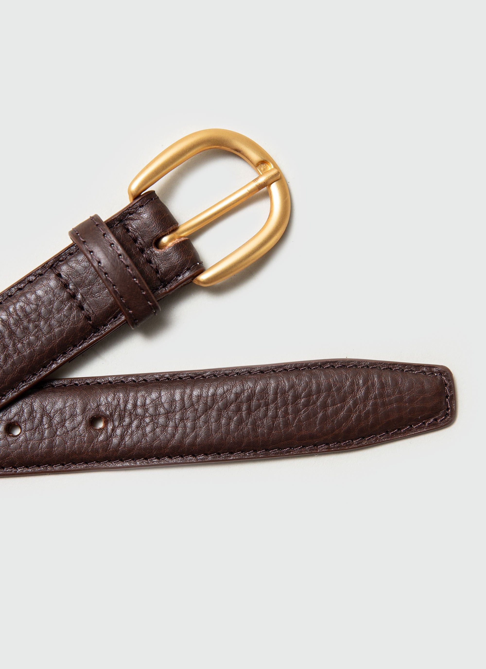 A close-up shot of the Percival brown leather dress belt, highlighting the classic gold buckle and textured leather.