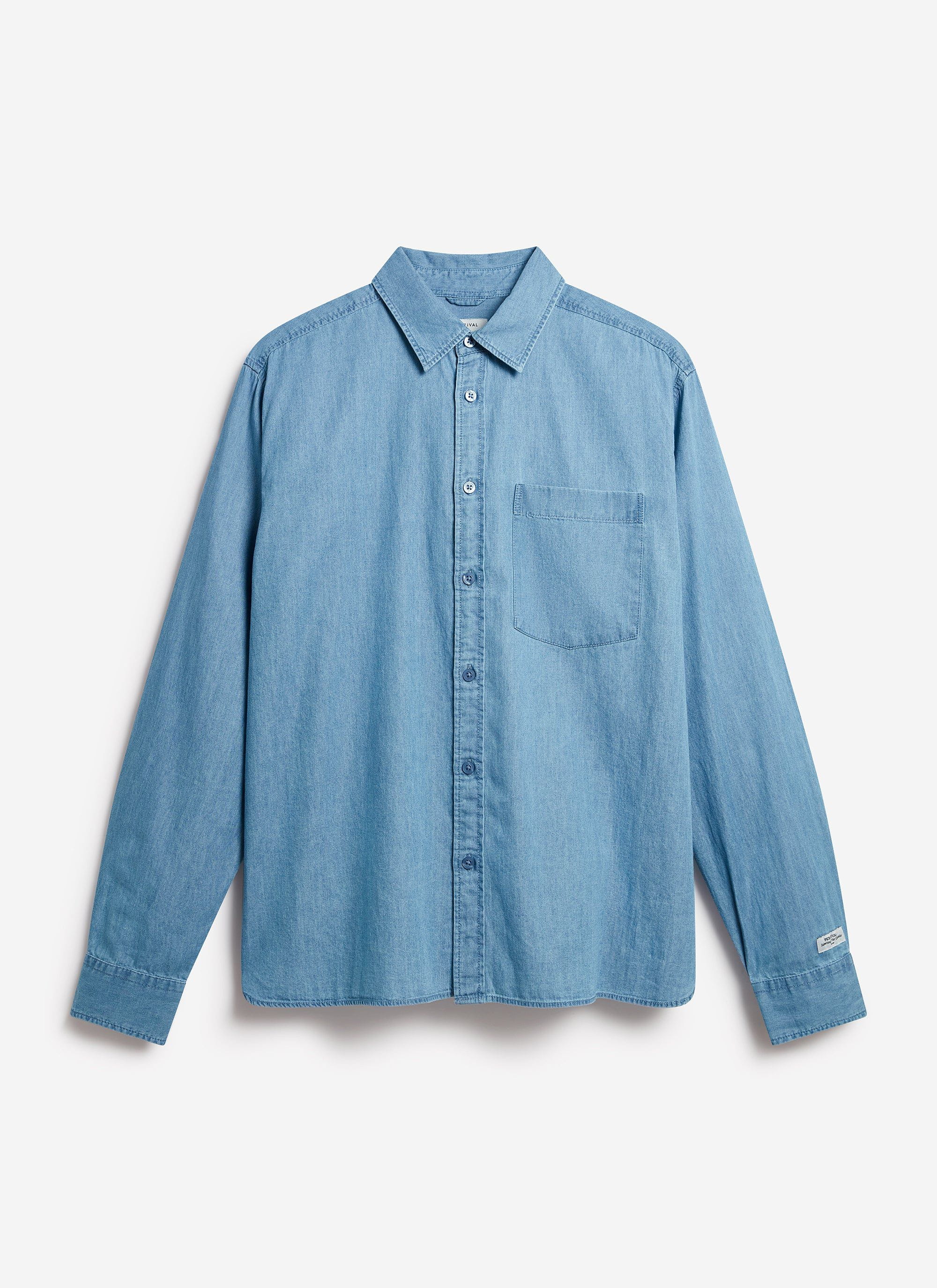 The Percival Marco Pearce Shirt in light wash blue denim, laid flat to showcase its relaxed fit and single chest pocket.