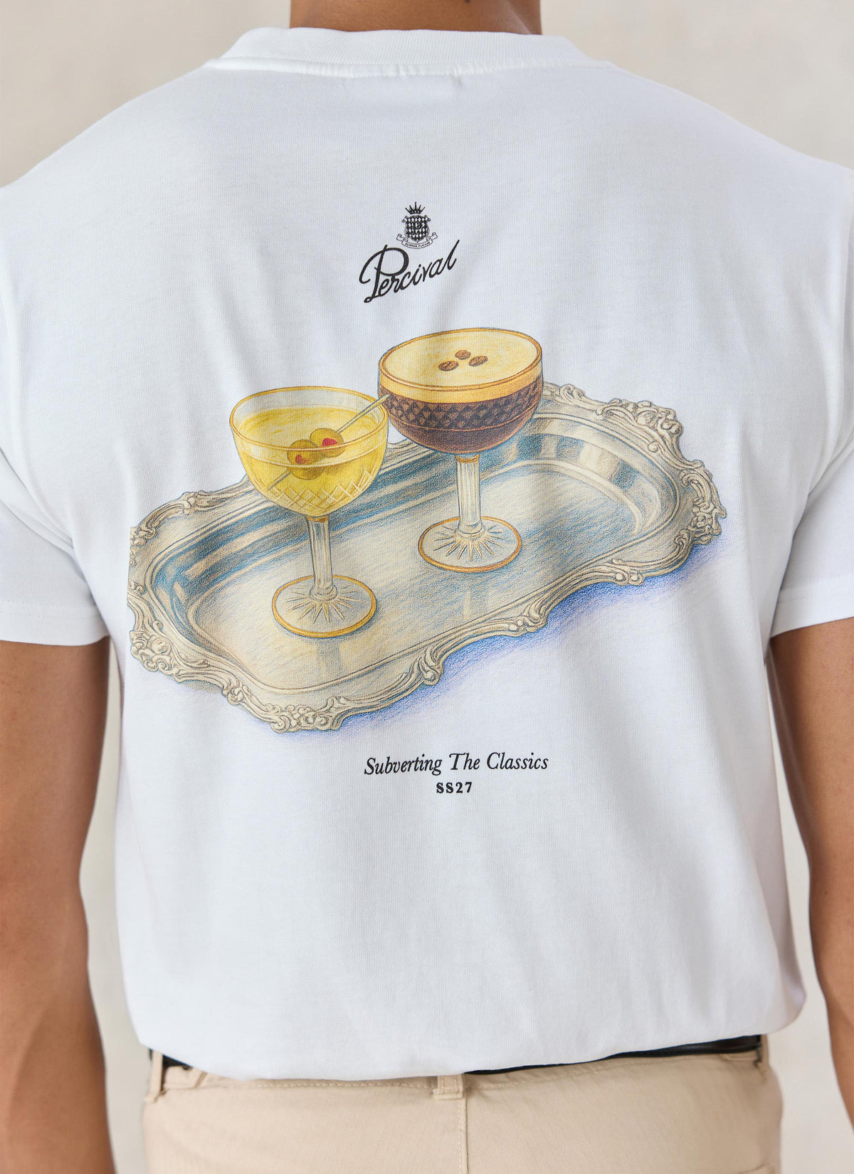 A close-up of the back of Percival's white Martini Duo T-shirt showing the illustrated two martinis on a silver tray graphic.