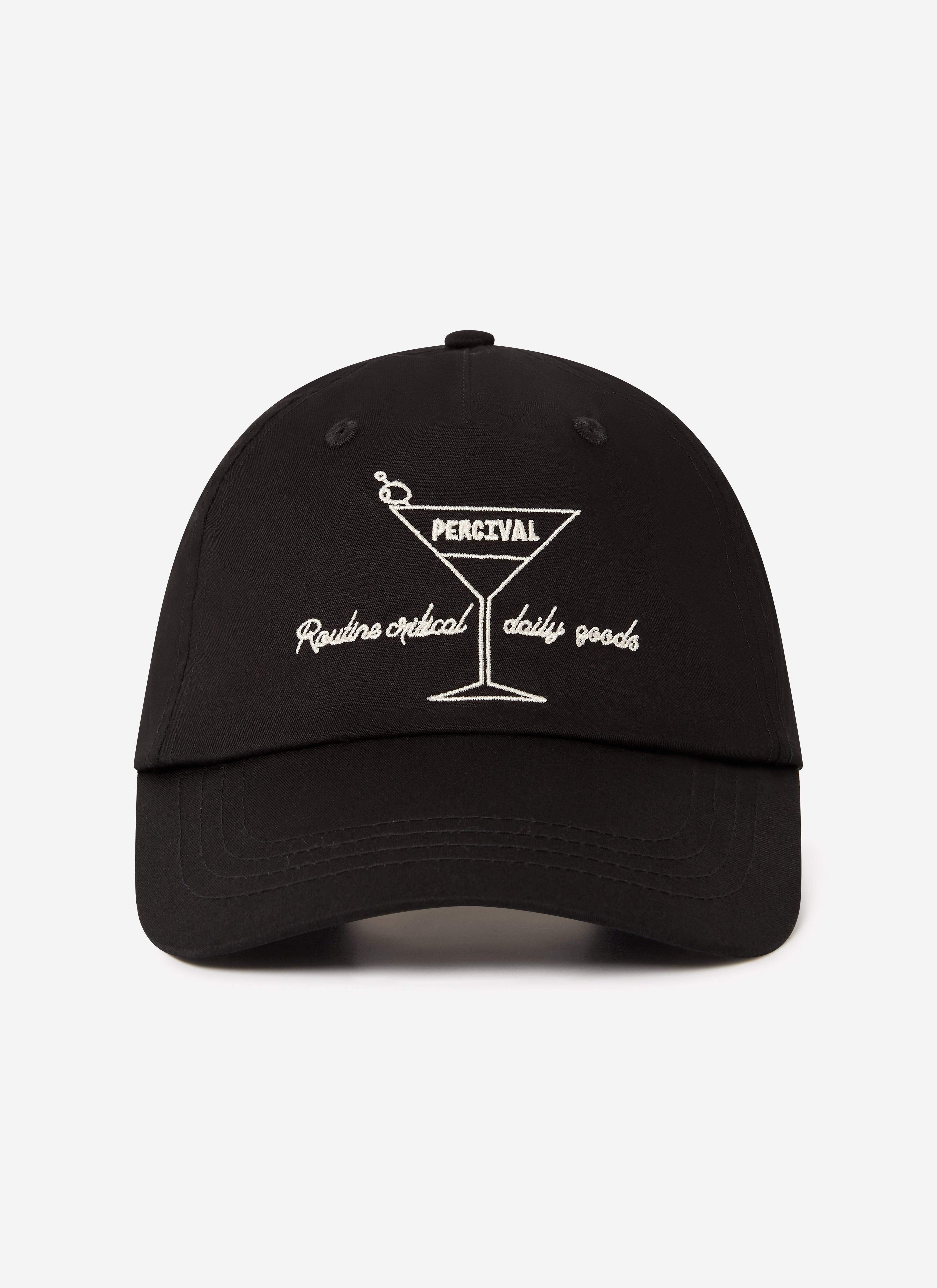 A front view of the Percival Martini Trucker Cap in black, featuring its signature white martini glass embroidery.
