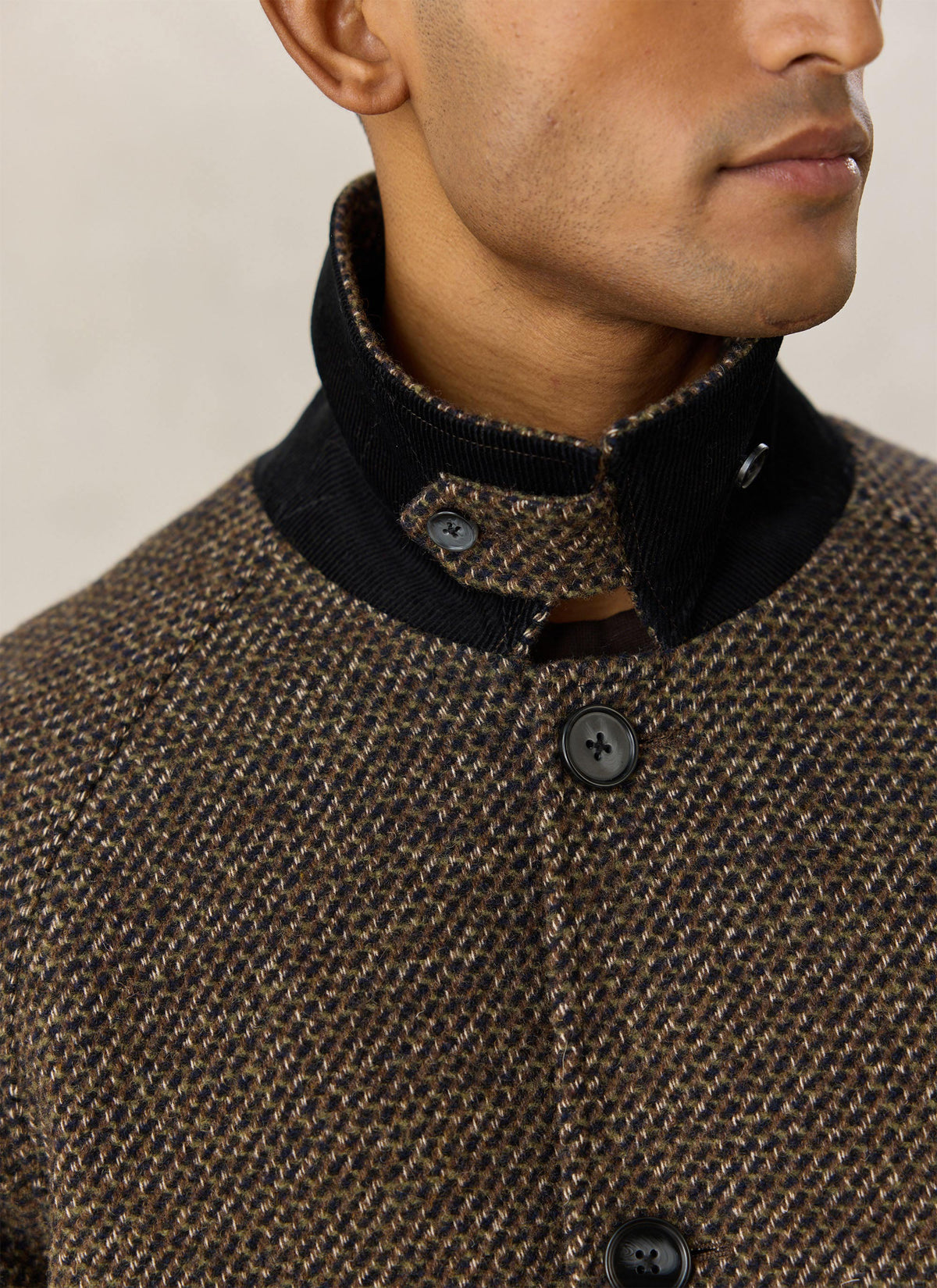 A close-up of the Percival brown fleck wool-blend Mason car coat, showing the collar detail and button front.