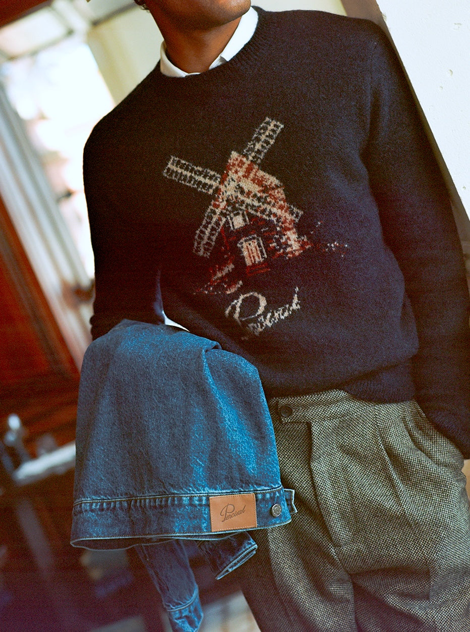 Percival navy wool jumper with windmill graphic, styled with birdseye wool trousers and a denim jacket.
