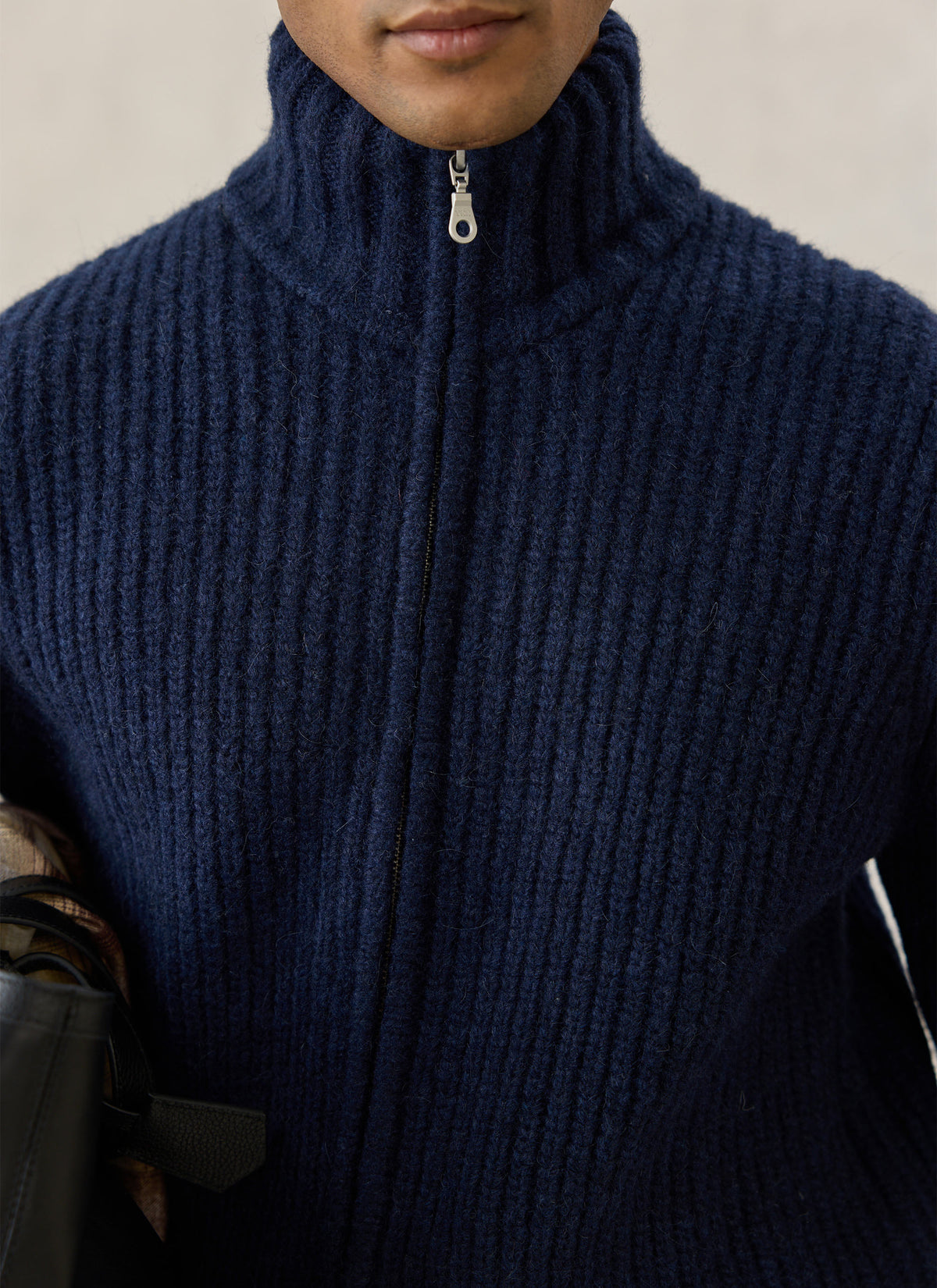 Close-up of the Percival navy ribbed fisherman zip cardigan showing the high collar and zip.