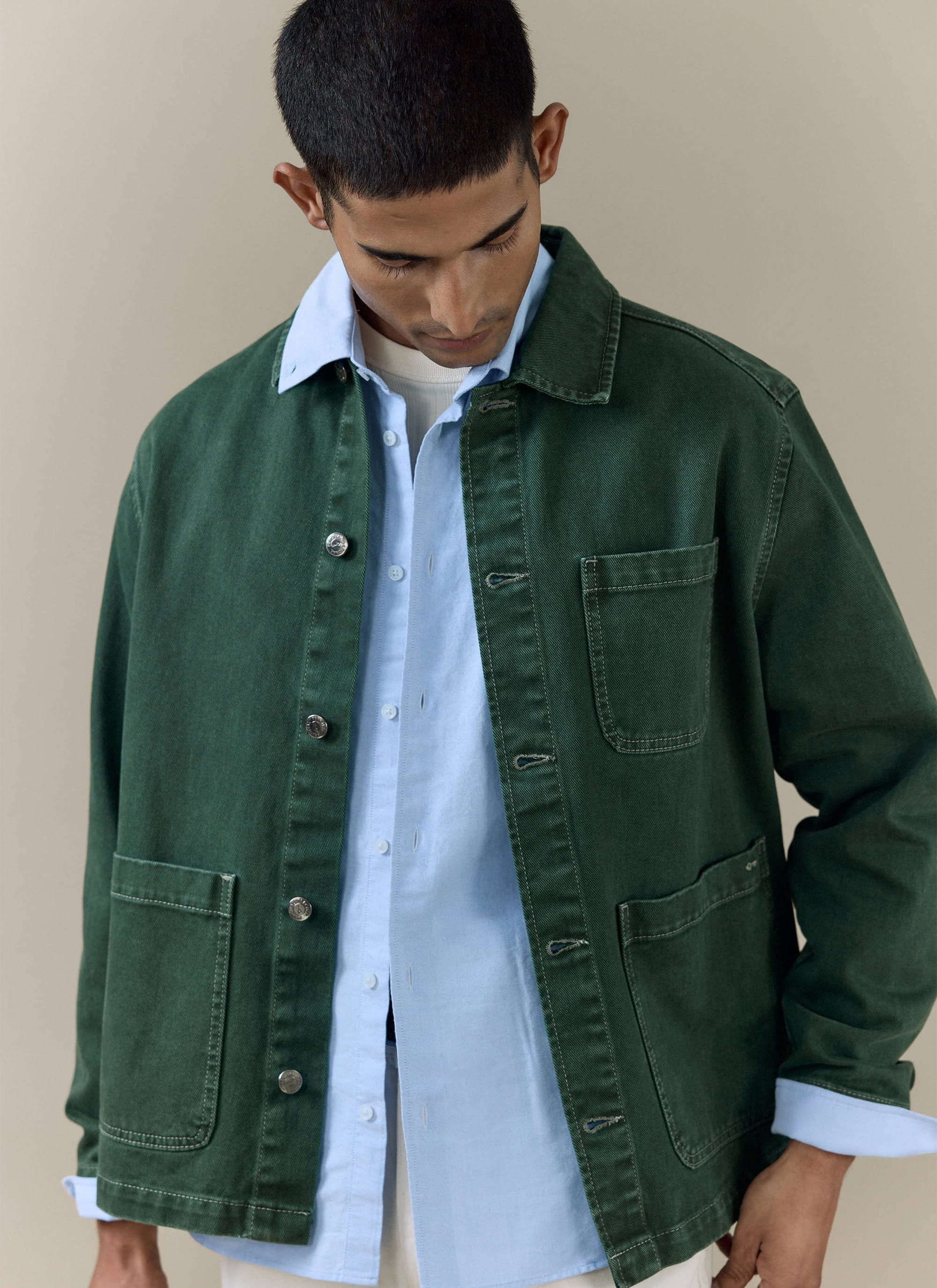 Percival forest green Vintage Wash Oliver Chore Jacket in cotton canvas, styled over a light blue shirt.