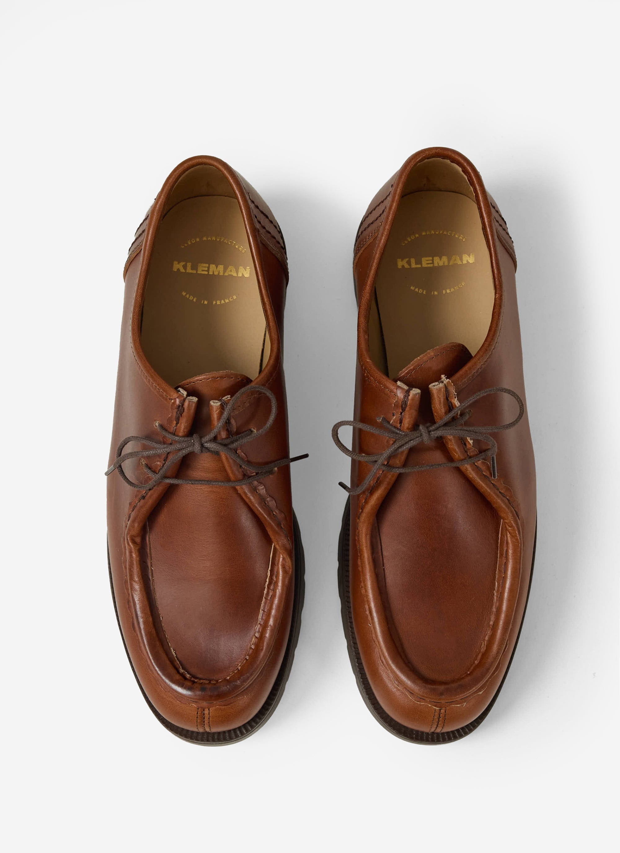 A top-down studio shot of the Percival Kleman Padror TH shoes in rich cognac leather, handmade in France.