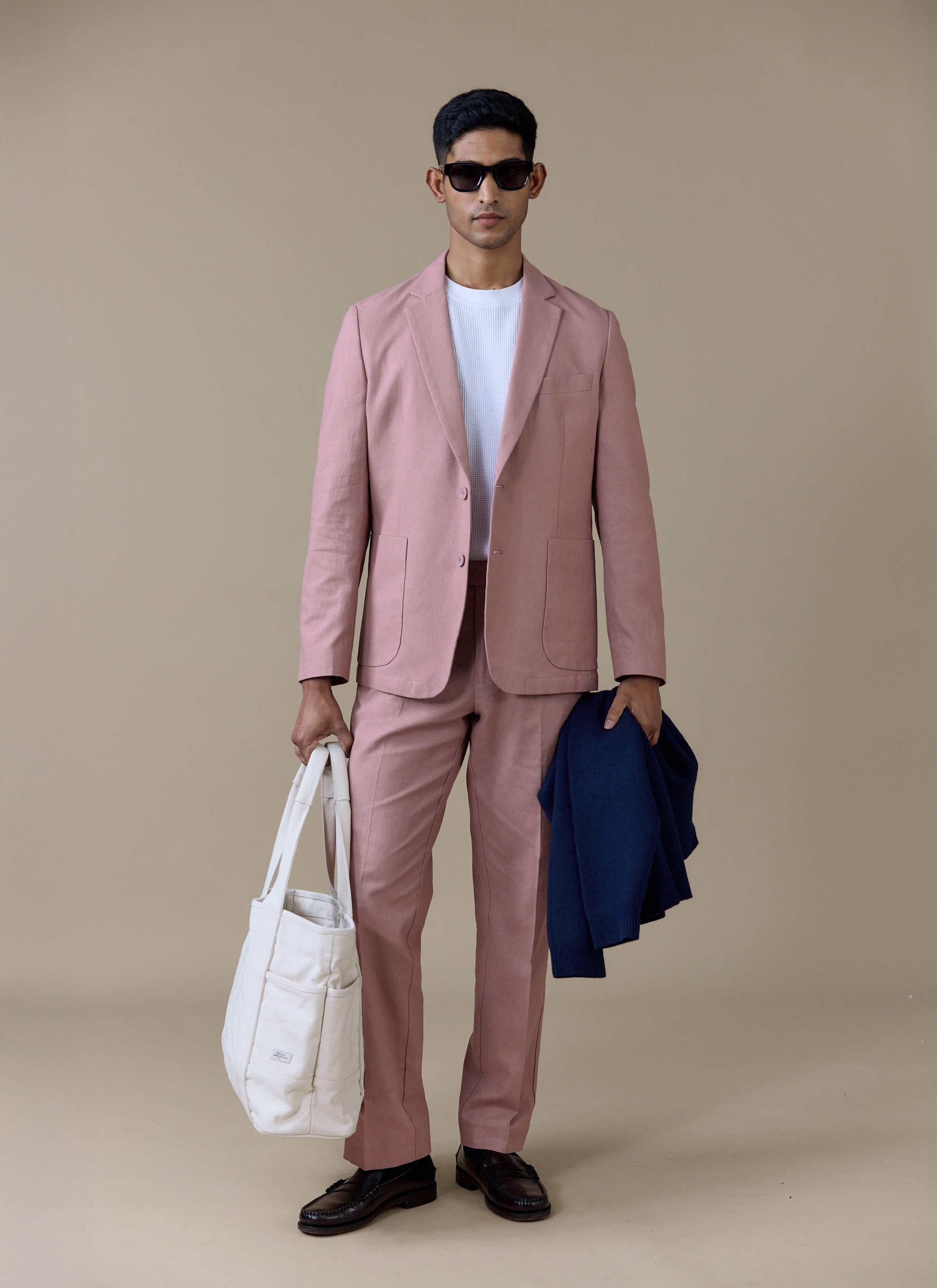 Percival tailored linen trousers and matching blazer in dusty pink, styled with a white tee and cream tote bag.