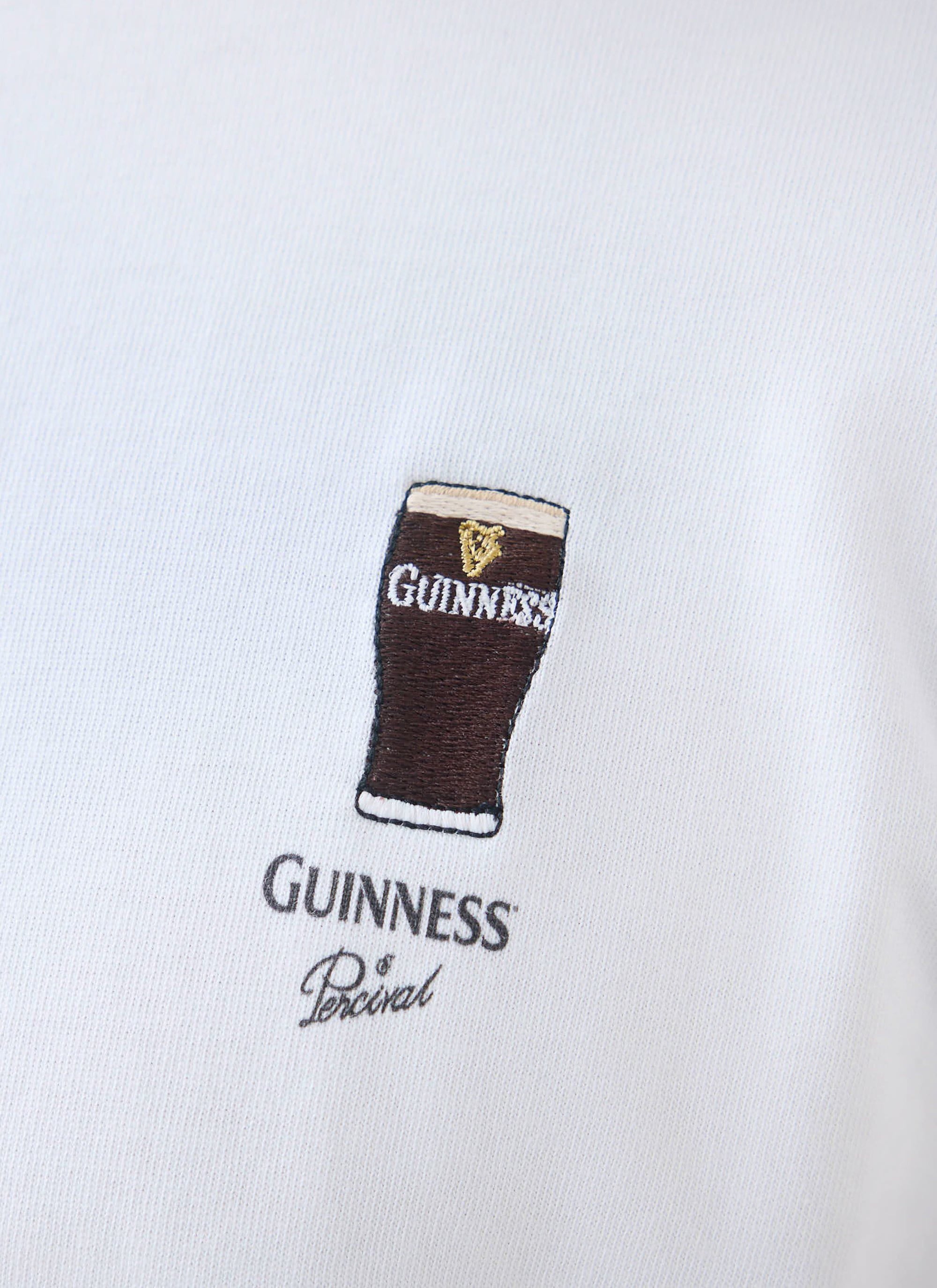 Close-up shot of the chest embroidery on the white Percival x Guinness Stout T-Shirt, featuring a pint of stout.