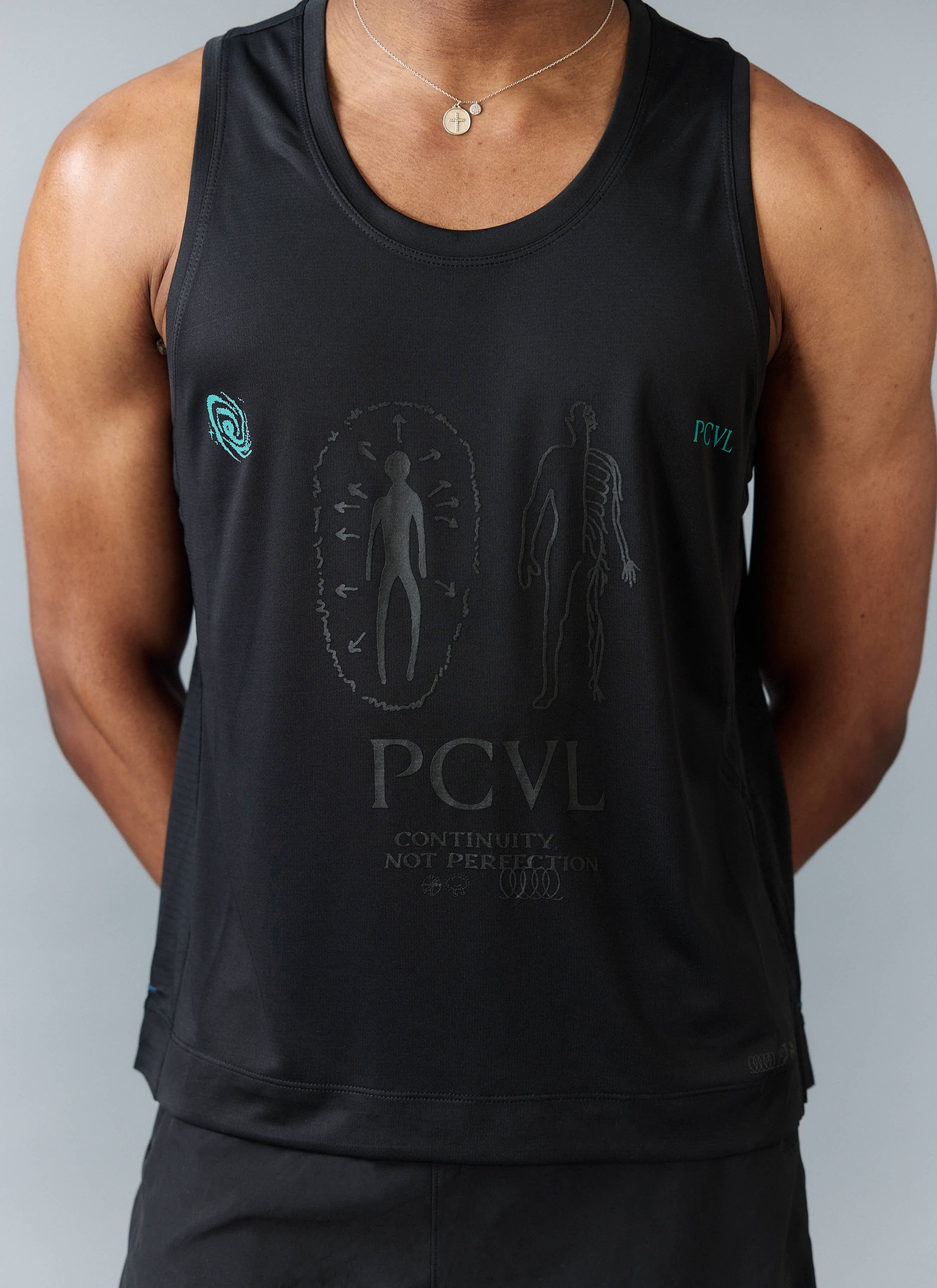 Close up of a model wearing the Percival PCVL Performance Vest in black, showing the tonal graphic print on the chest.