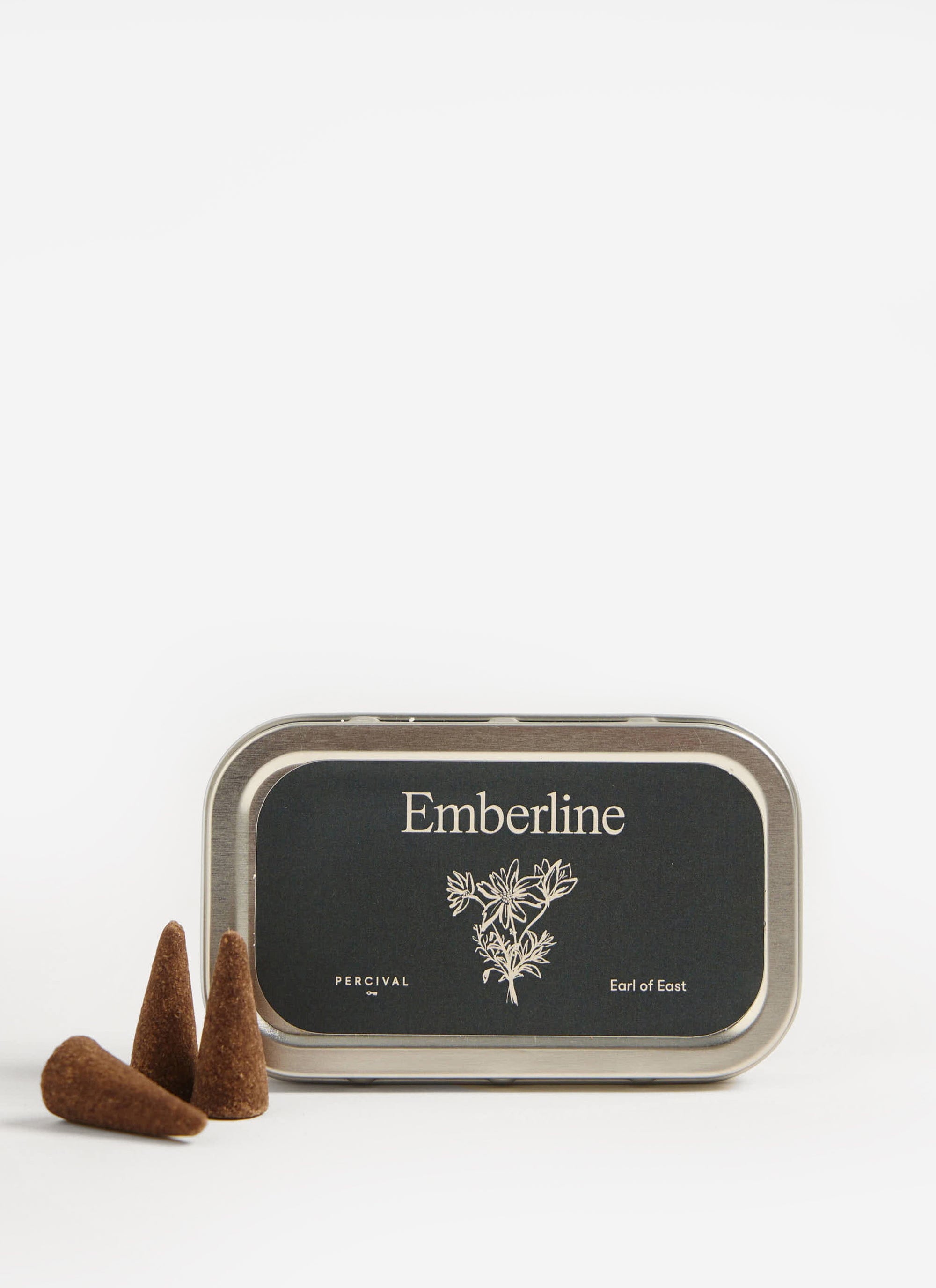 The Percival x Earl of East Emberline incense cones, with three cones displayed next to the branded silver tin.