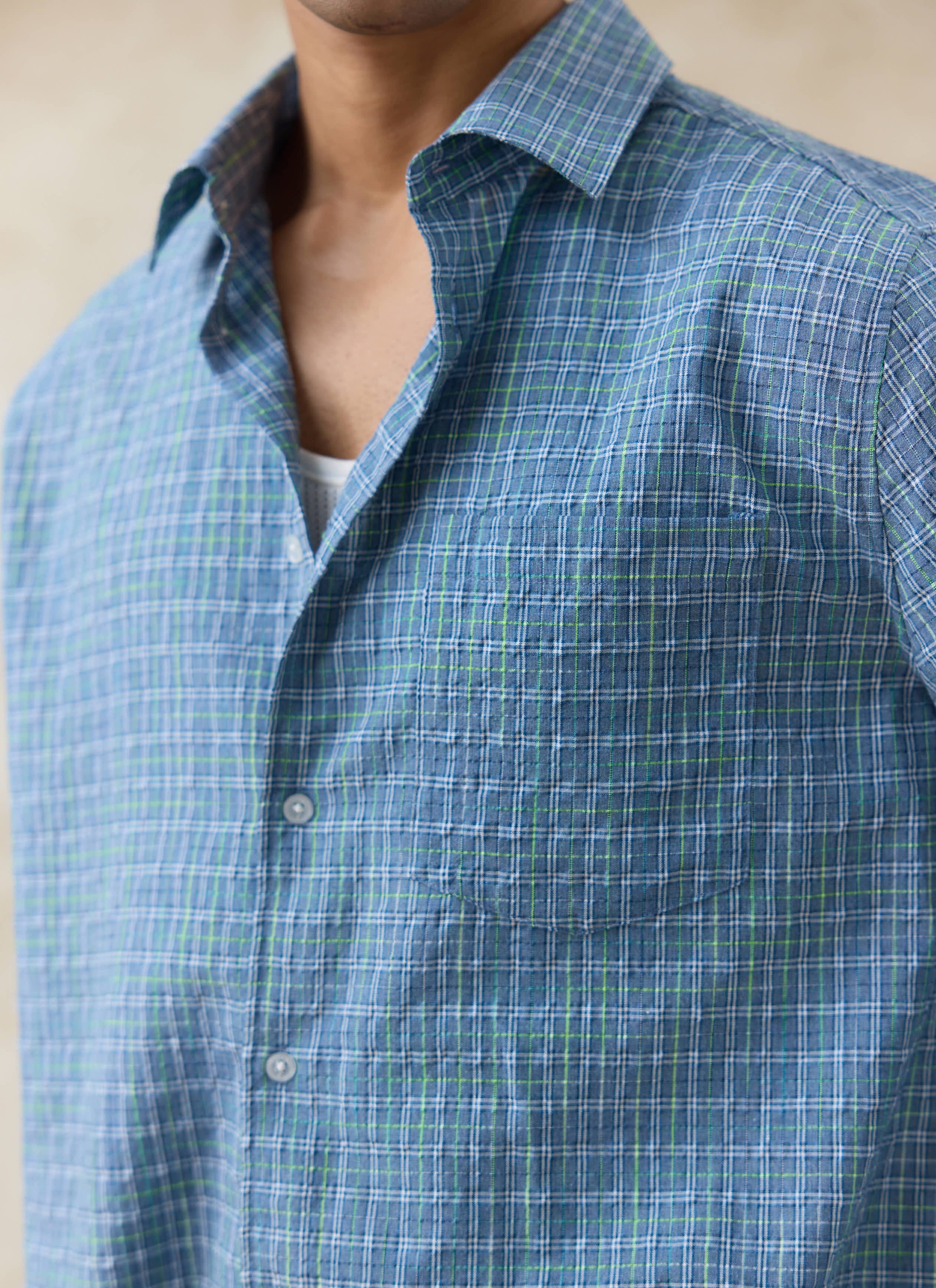 Close-up of the blue Percival Hinsley Checked Boxy Shirt in textured cotton, featuring a green and white grid pattern.