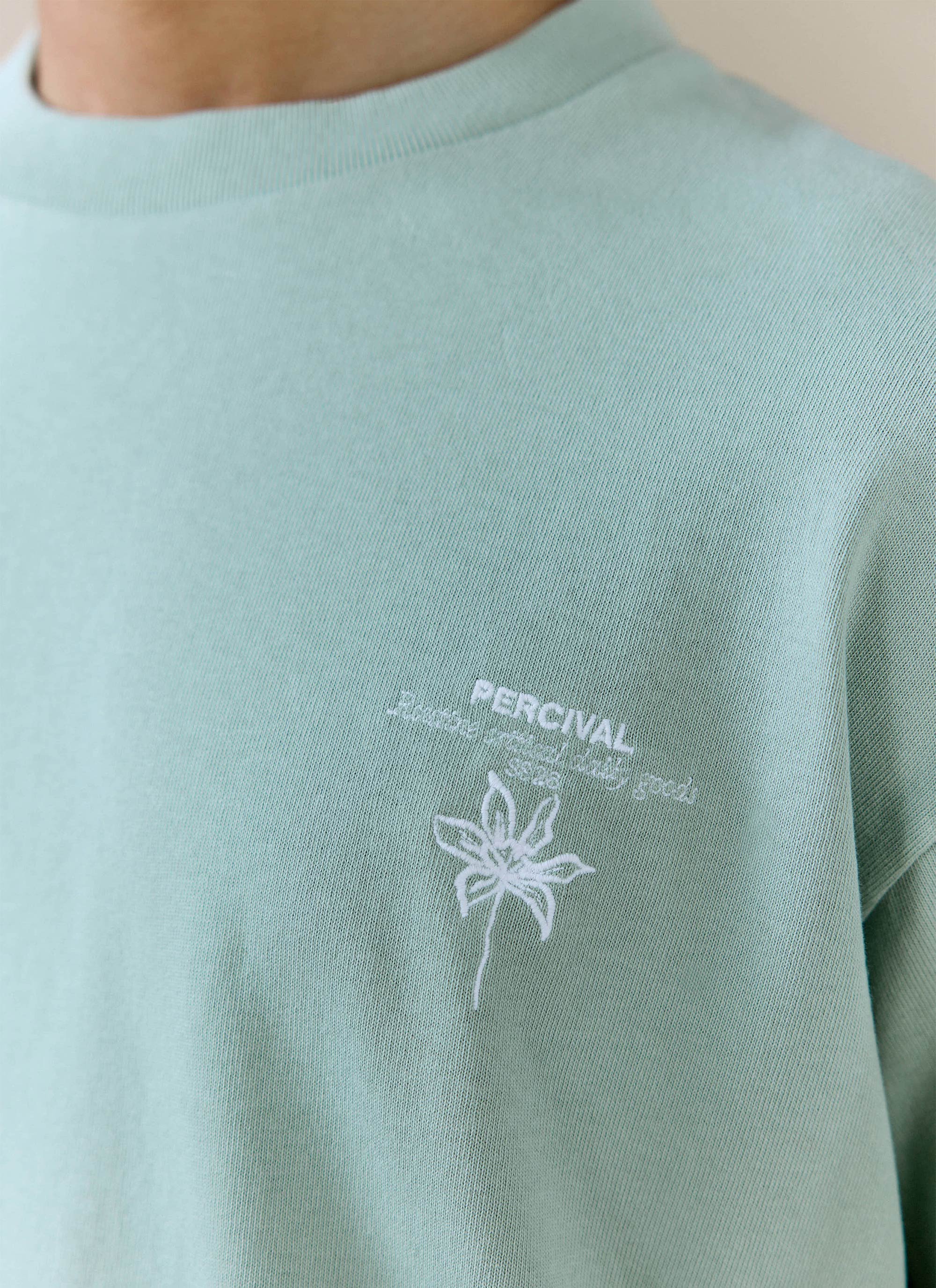 Sage green organic cotton Melvin Oversized T-shirt by Percival, featuring detailed white flower chest embroidery.