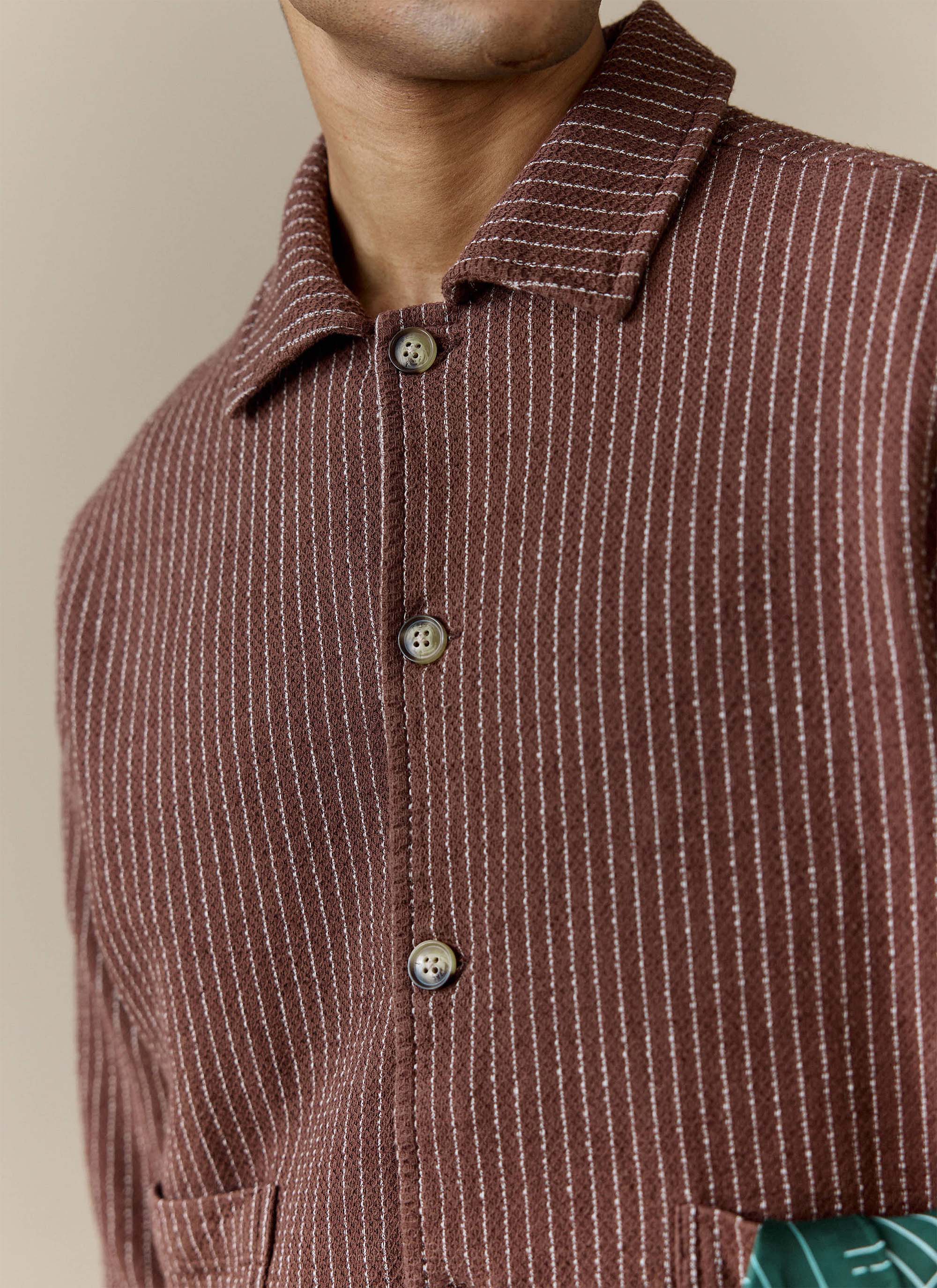 A close-up of the Percival Sorrento Boxy Overshirt, highlighting the brown pinstripe linen-cotton blend fabric and buttons.