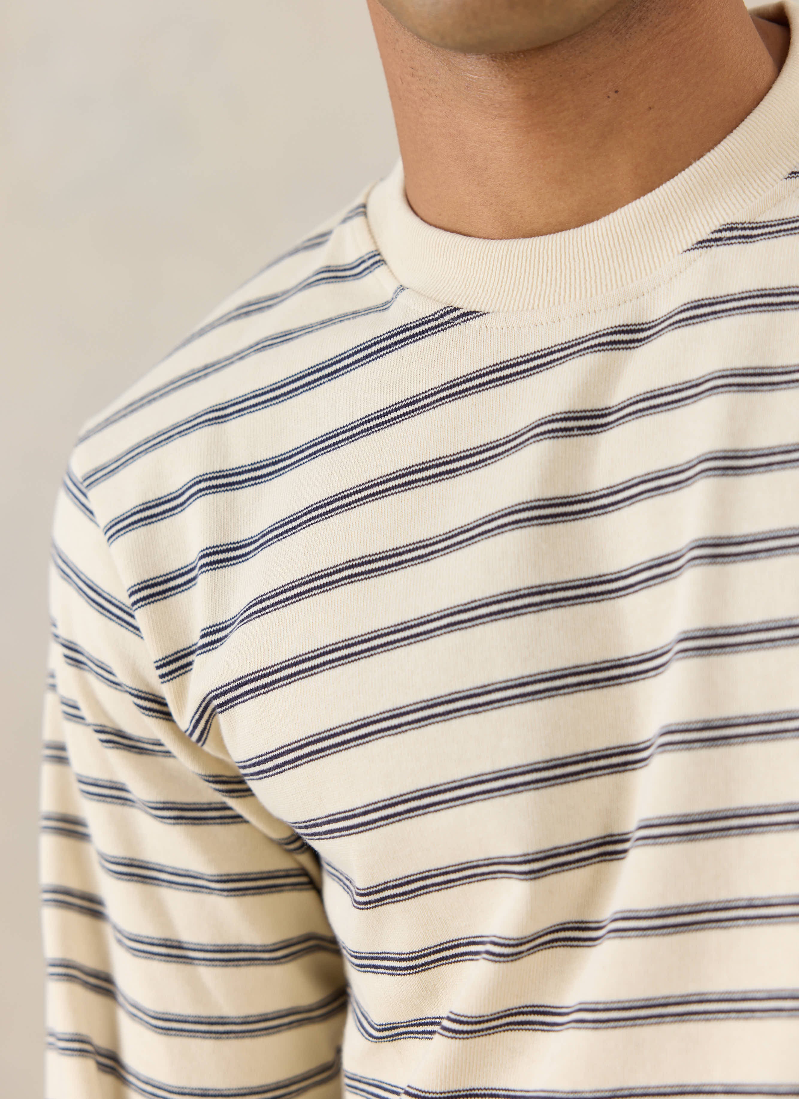 Close-up of the Percival Arlo Raw Hem Long Sleeve Breton T-Shirt in white stripe, highlighting the ribbed crew neck.