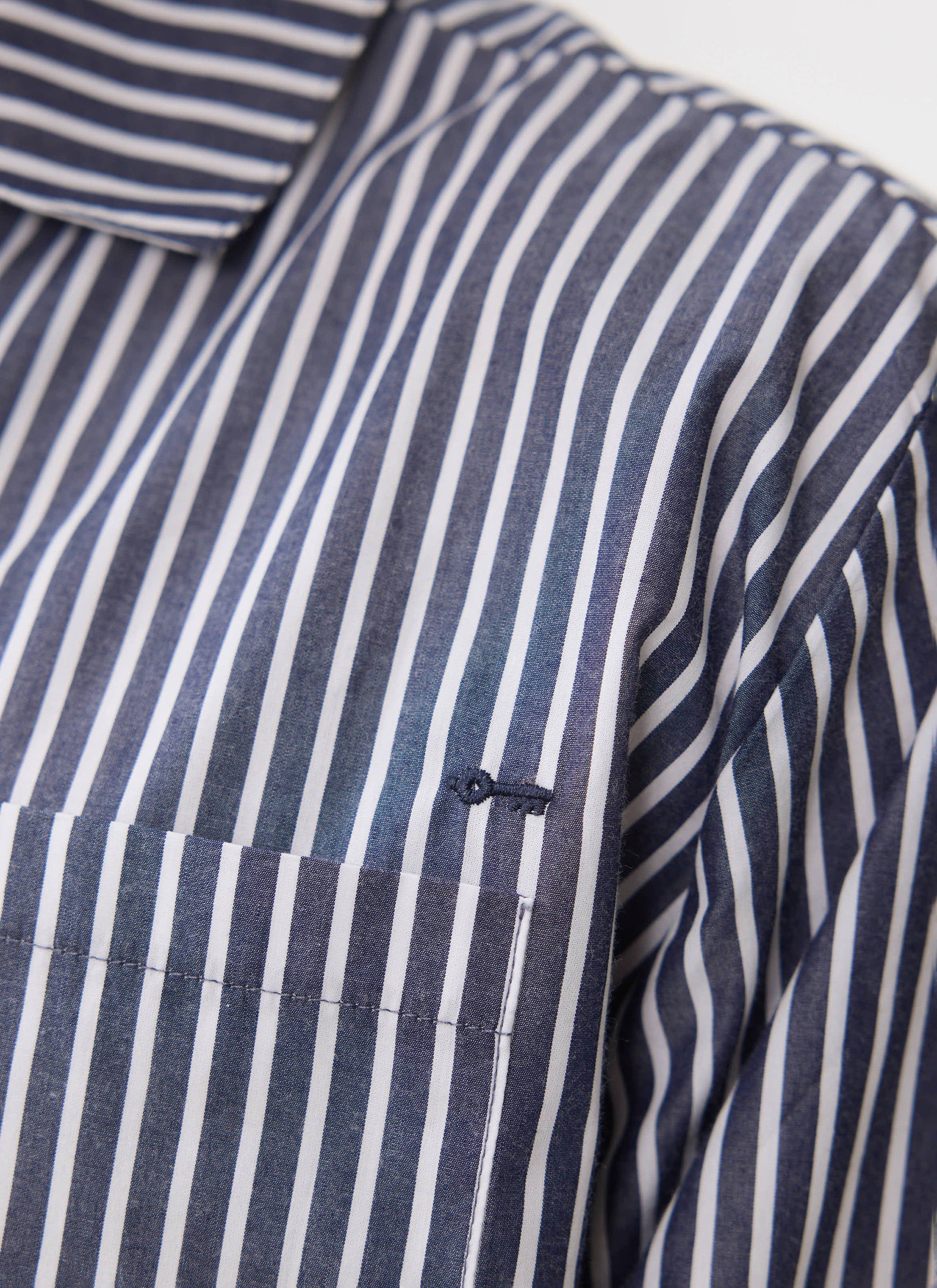 A close-up of the Percival blue and white striped cotton Pyjama Top, showing the chest pocket and embroidered key detail.